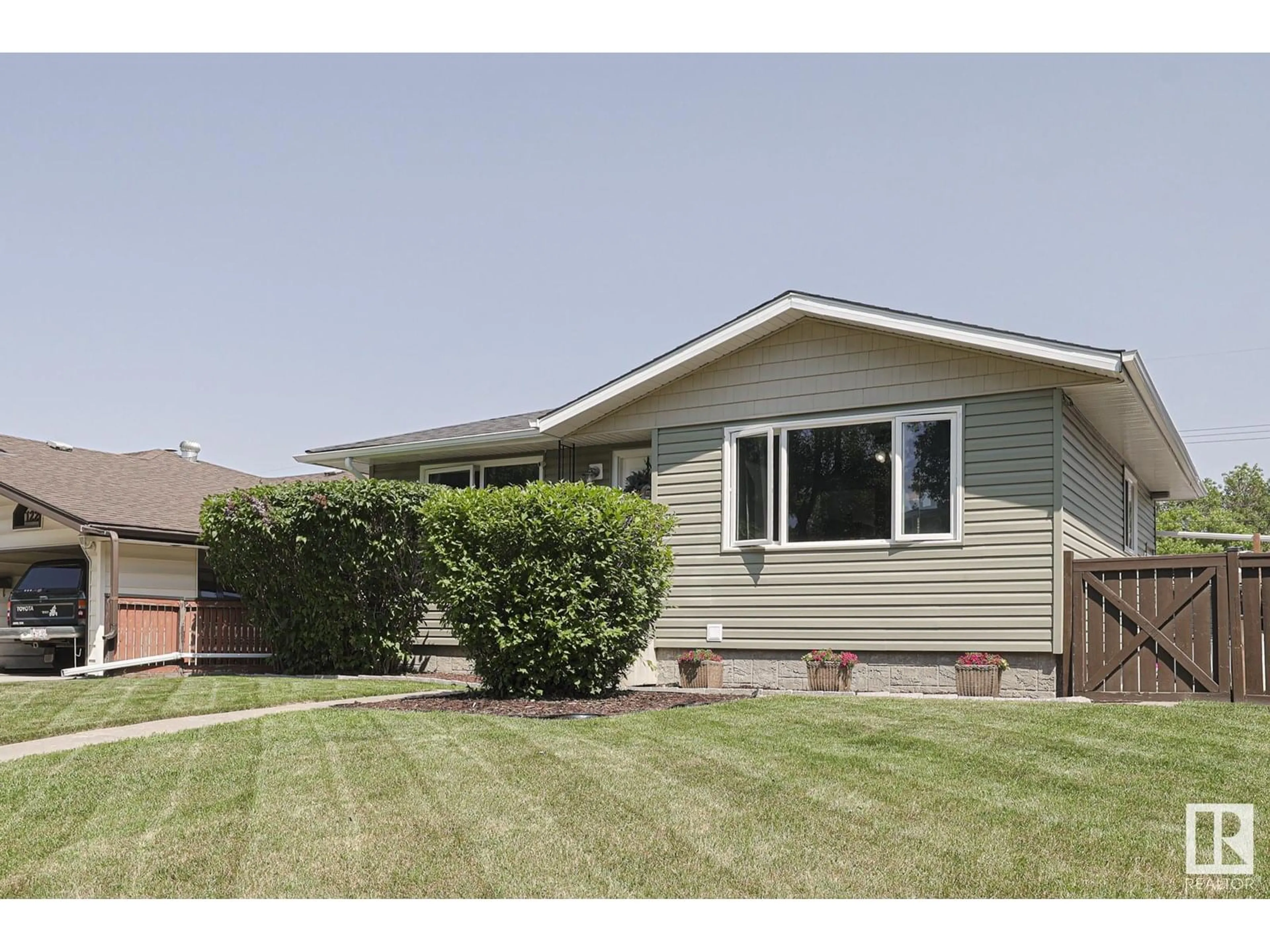 Home with vinyl exterior material, street for NW - 12207 42 ST, Edmonton Alberta T5W2P2