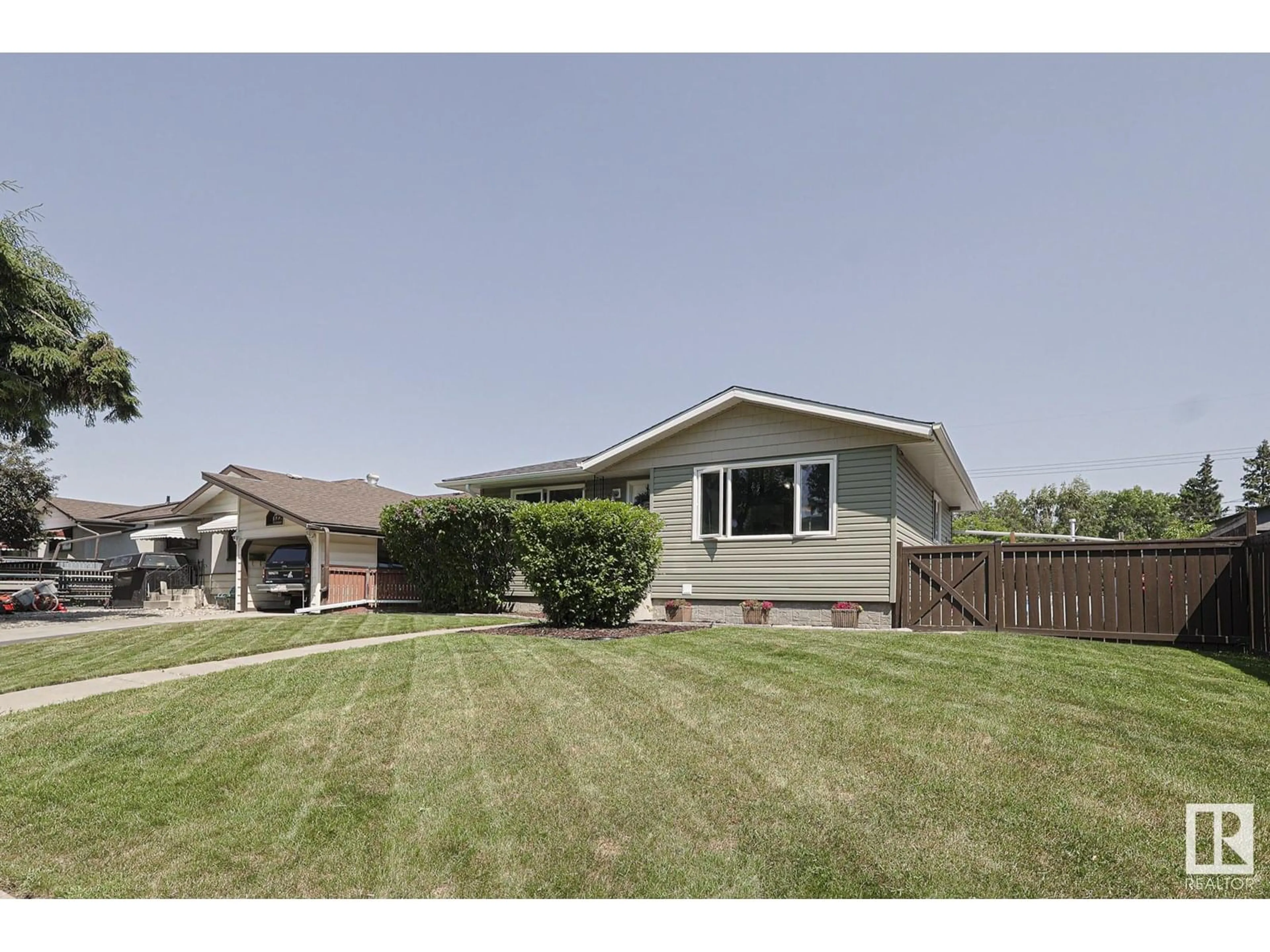 Home with vinyl exterior material, street for NW - 12207 42 ST, Edmonton Alberta T5W2P2