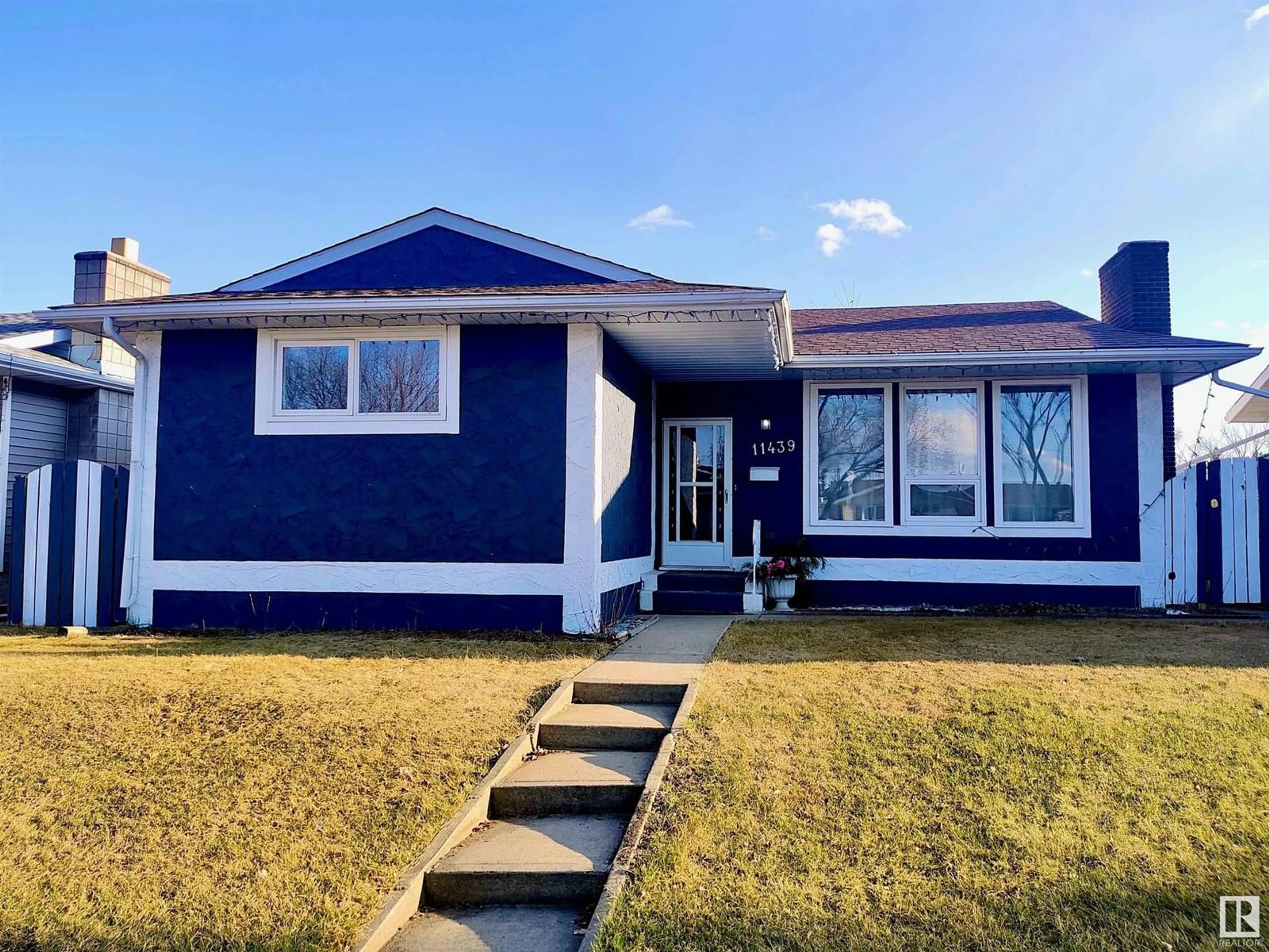 Home with vinyl exterior material, street for 11439 145 AV, Edmonton Alberta T5X1M1