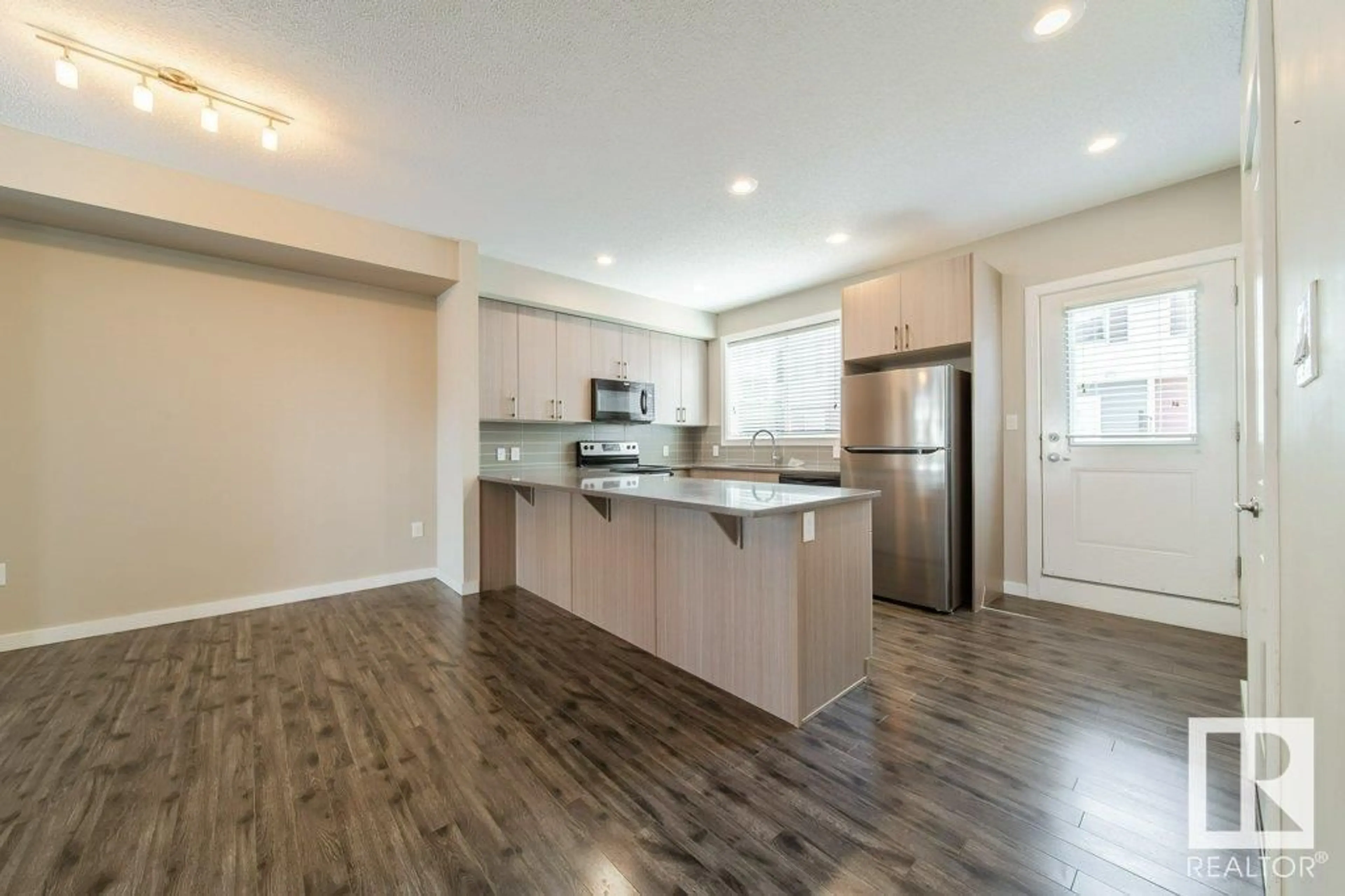 Open concept kitchen, wood/laminate floor for 74 - 2803 JAMES MOWATT TR, Edmonton Alberta T6W2P5
