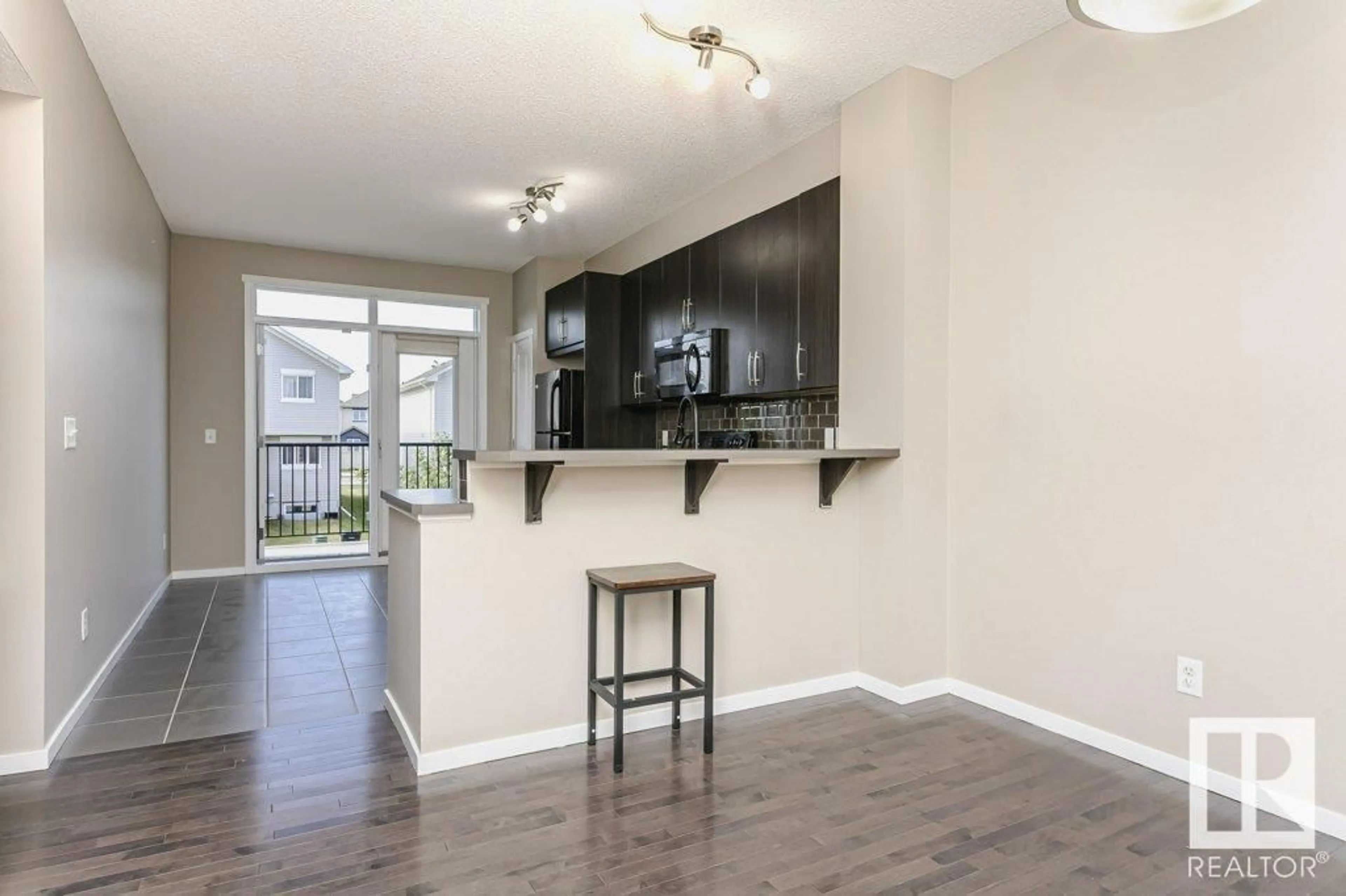 Open concept kitchen, wood/laminate floor for #137 - 603 WATT BV, Edmonton Alberta T6X0P3