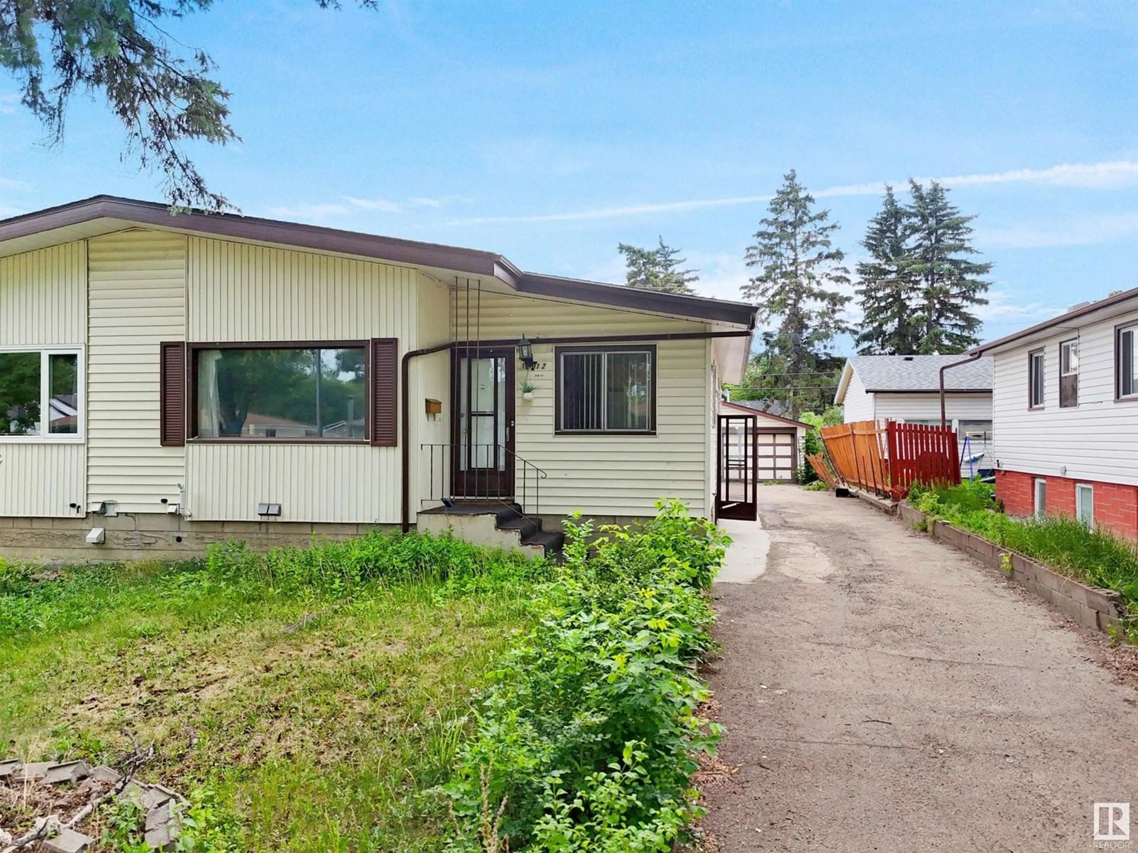 Home with vinyl exterior material, street for 12012 49 ST, Edmonton Alberta T5W3A4