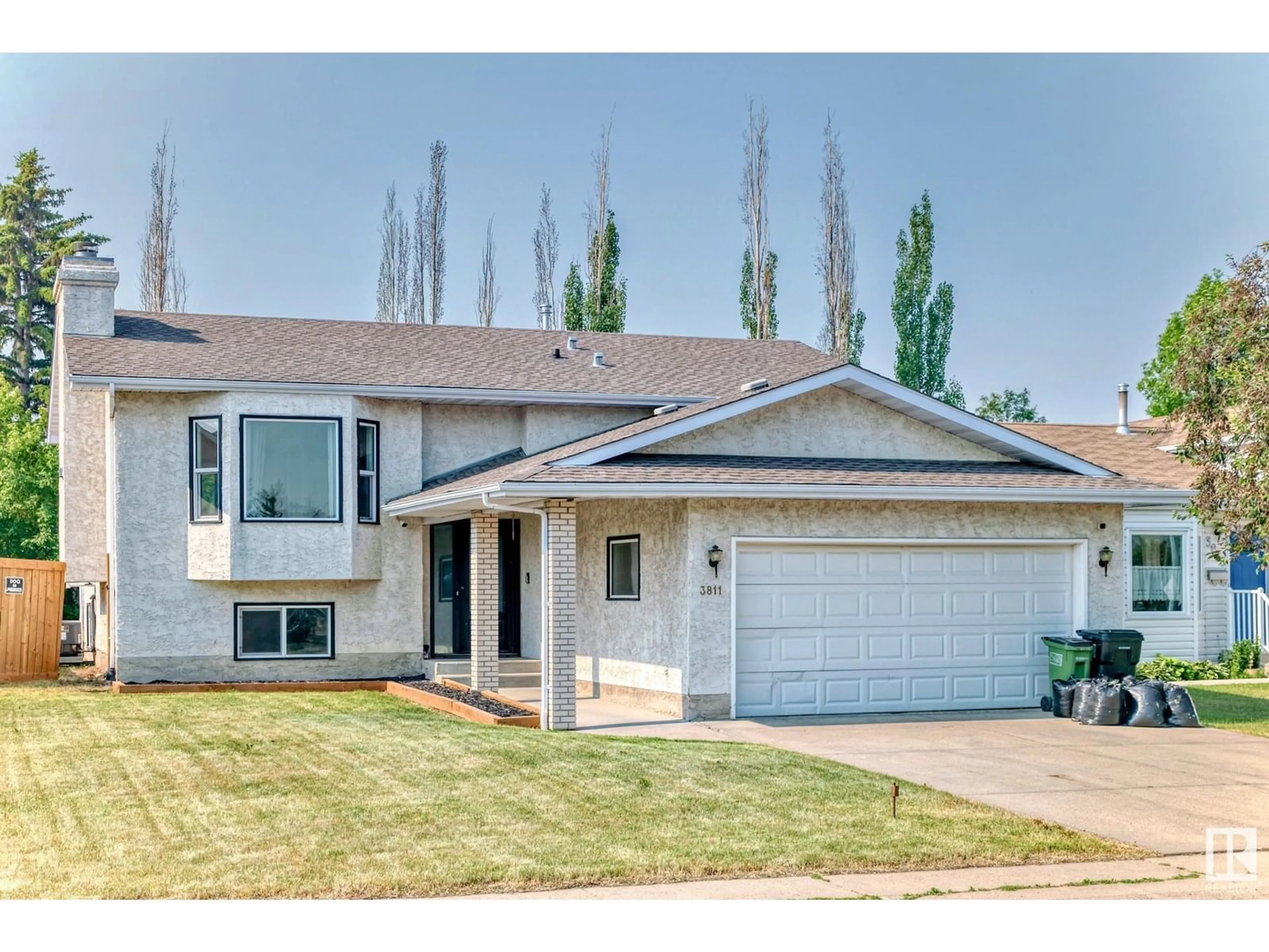 Home with vinyl exterior material, street for 3811 21 AV, Edmonton Alberta T6L4T4