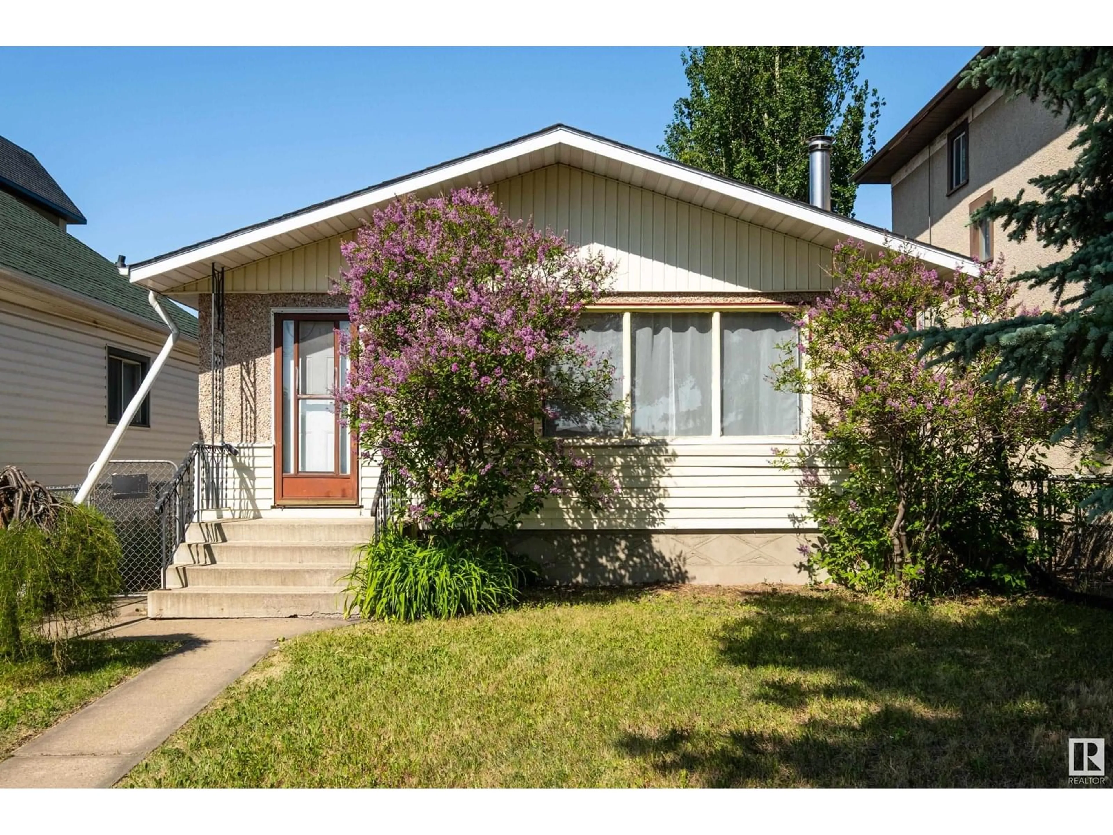 Home with vinyl exterior material, street for 11406 81 ST, Edmonton Alberta T5B2R6