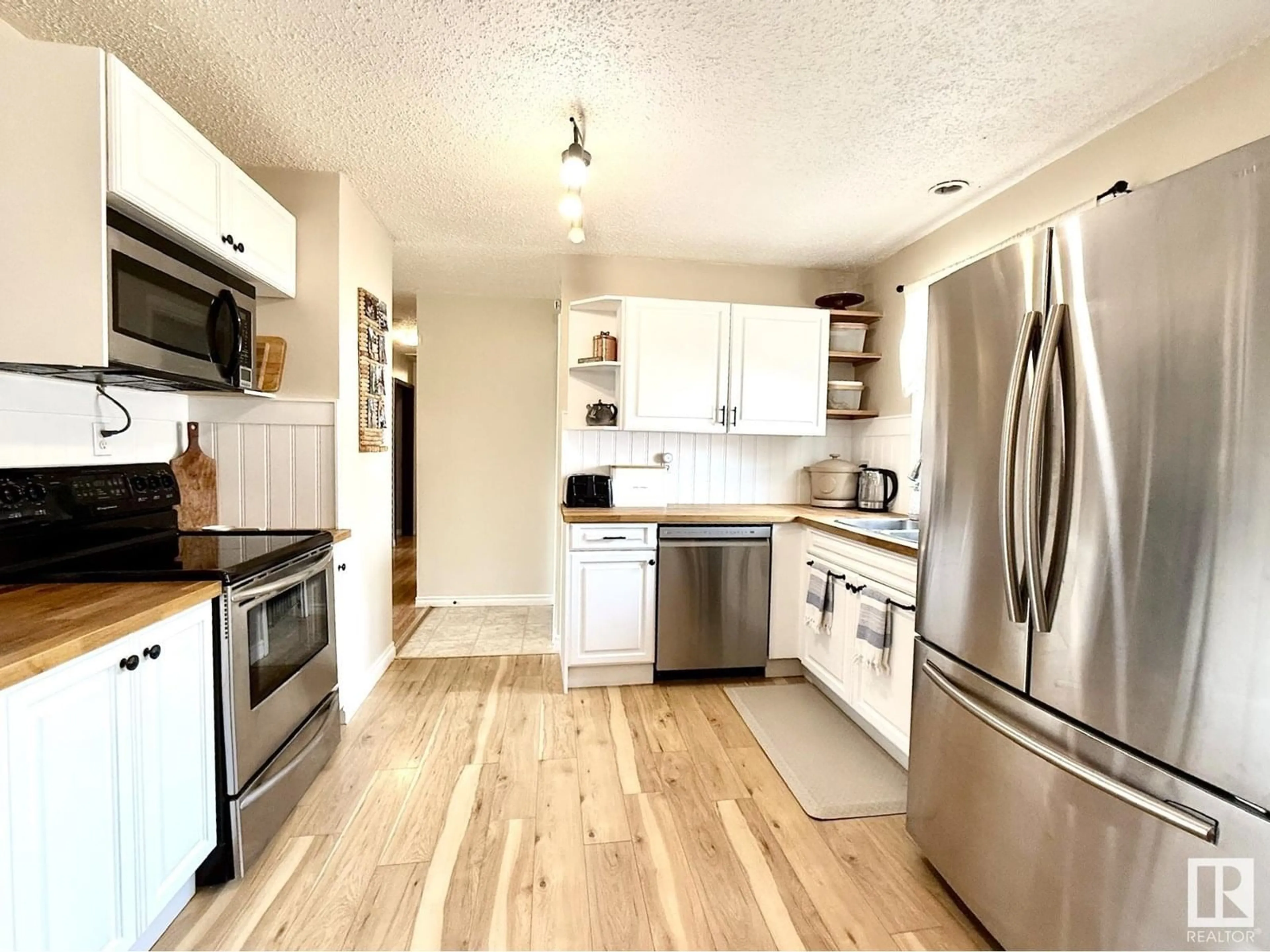 Open concept kitchen, wood/laminate floor for 4920 48 AV, Bon Accord Alberta T0A0K0