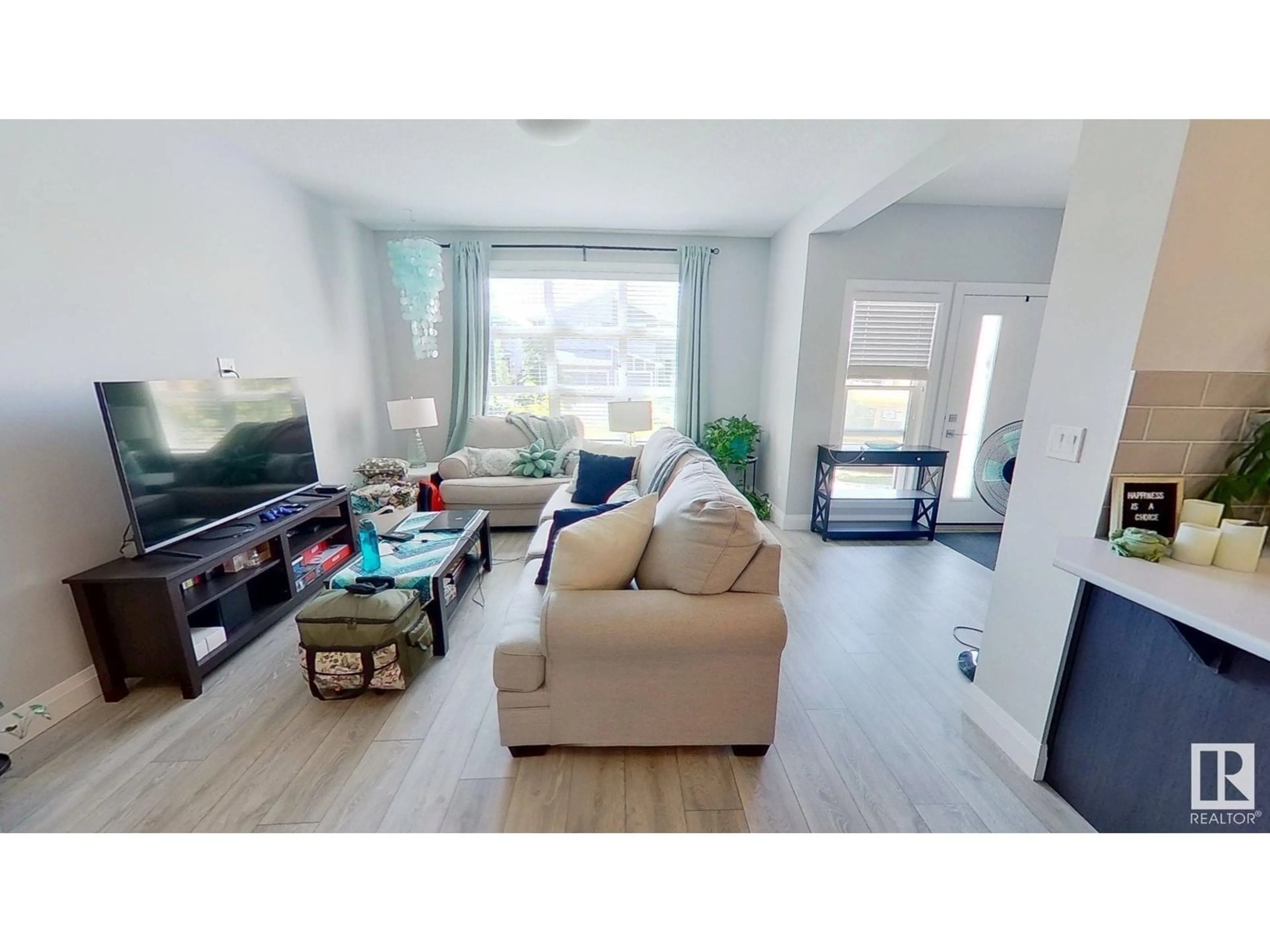 Living room with furniture, wood/laminate floor for 3632 8 AV, Edmonton Alberta T6X2G6