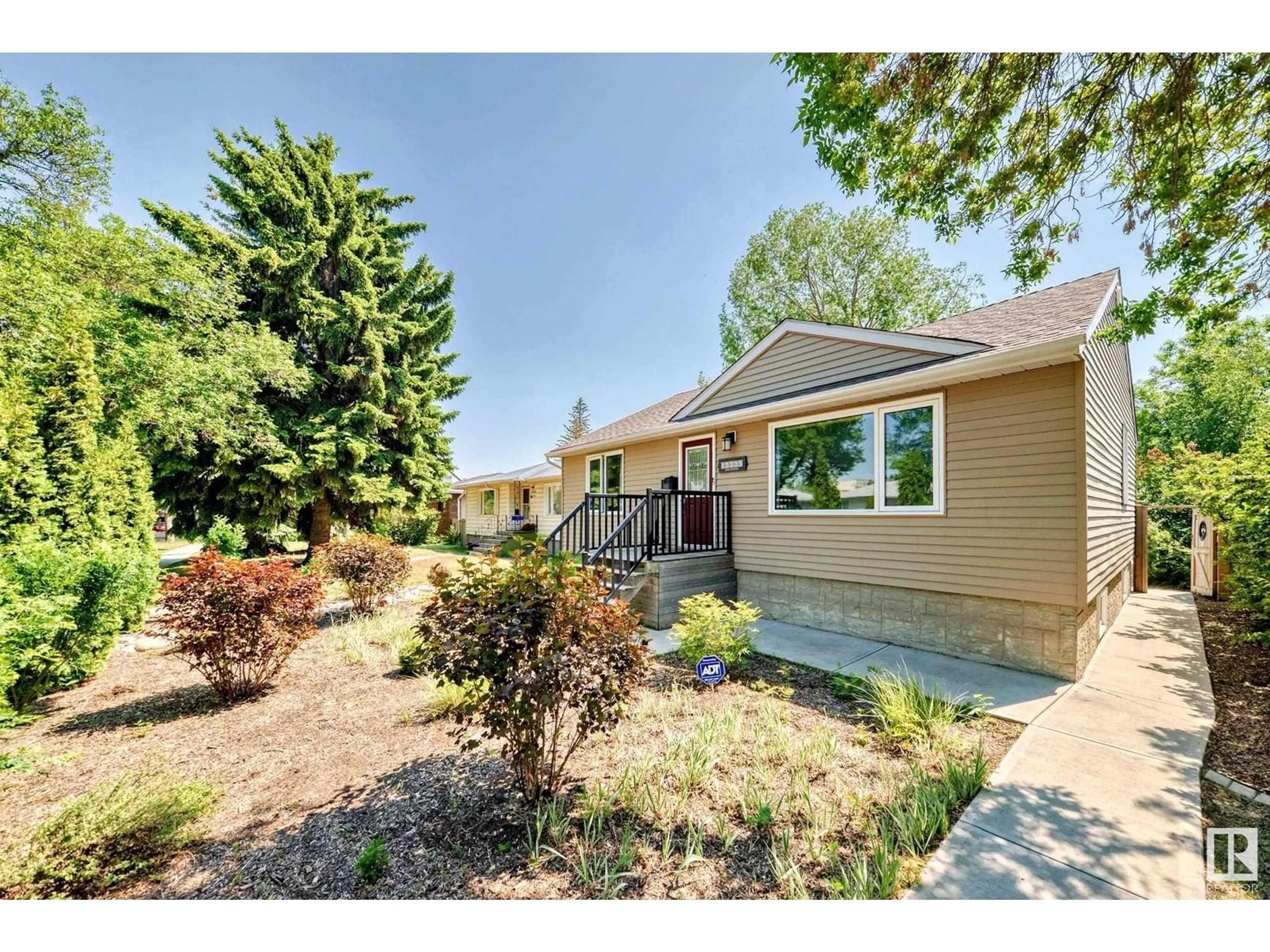 Home with vinyl exterior material, street for NW - 13335 110A AV, Edmonton Alberta T5M2M6