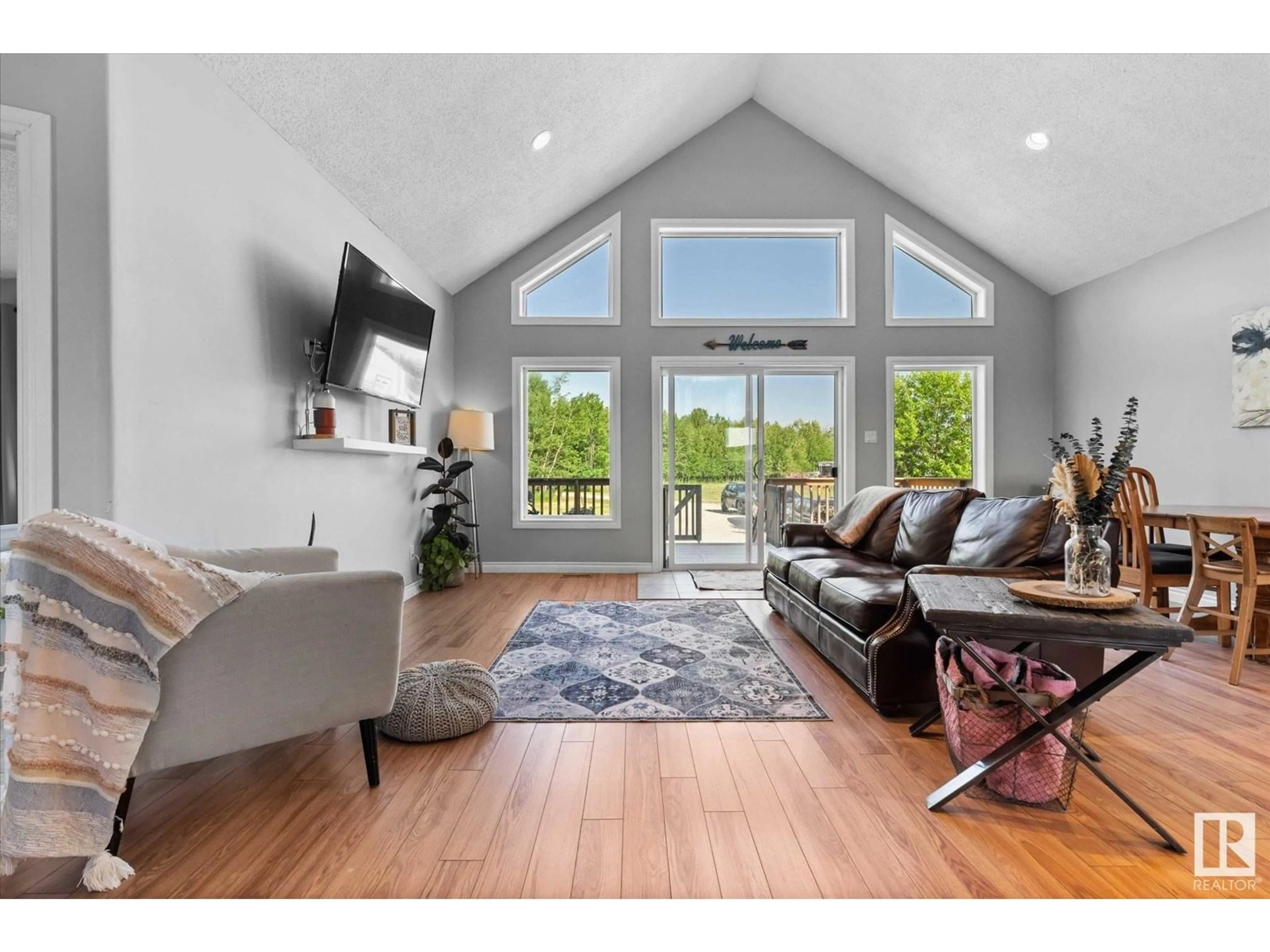 Living room with furniture, wood/laminate floor for 54310 RGE ROAD 24, Rural Lac Ste. Anne County Alberta T0E1V0