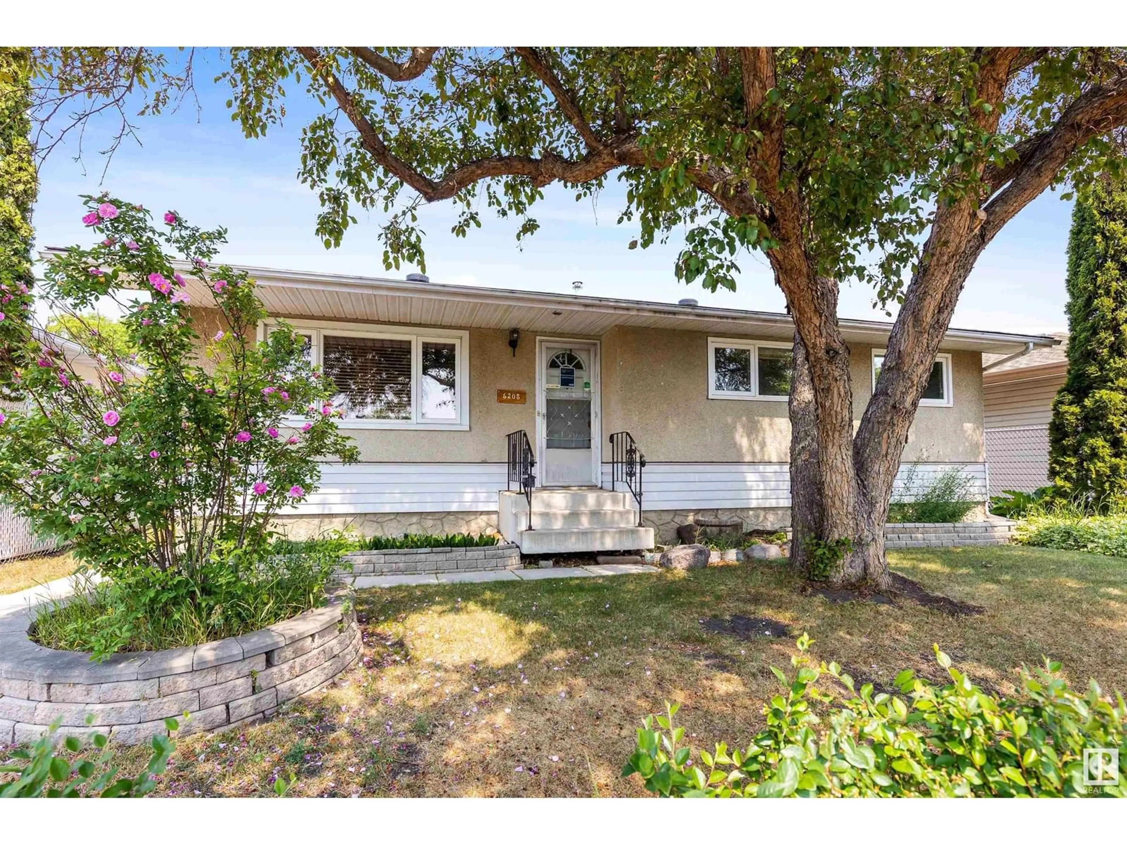 Home with vinyl exterior material, street for 6208 137 AV, Edmonton Alberta T5A1C9