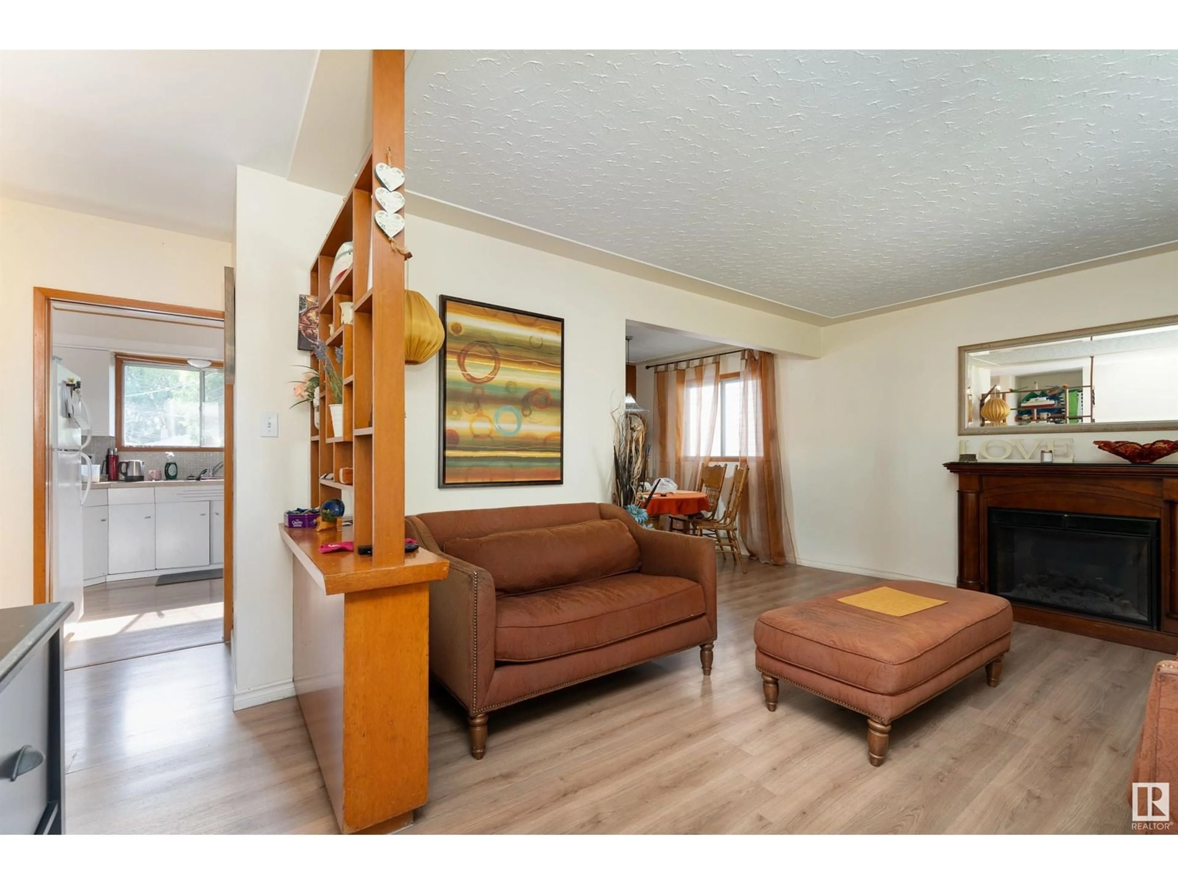 Living room with furniture, wood/laminate floor for 10421 - 10419 78 ST, Edmonton Alberta T6A3E7