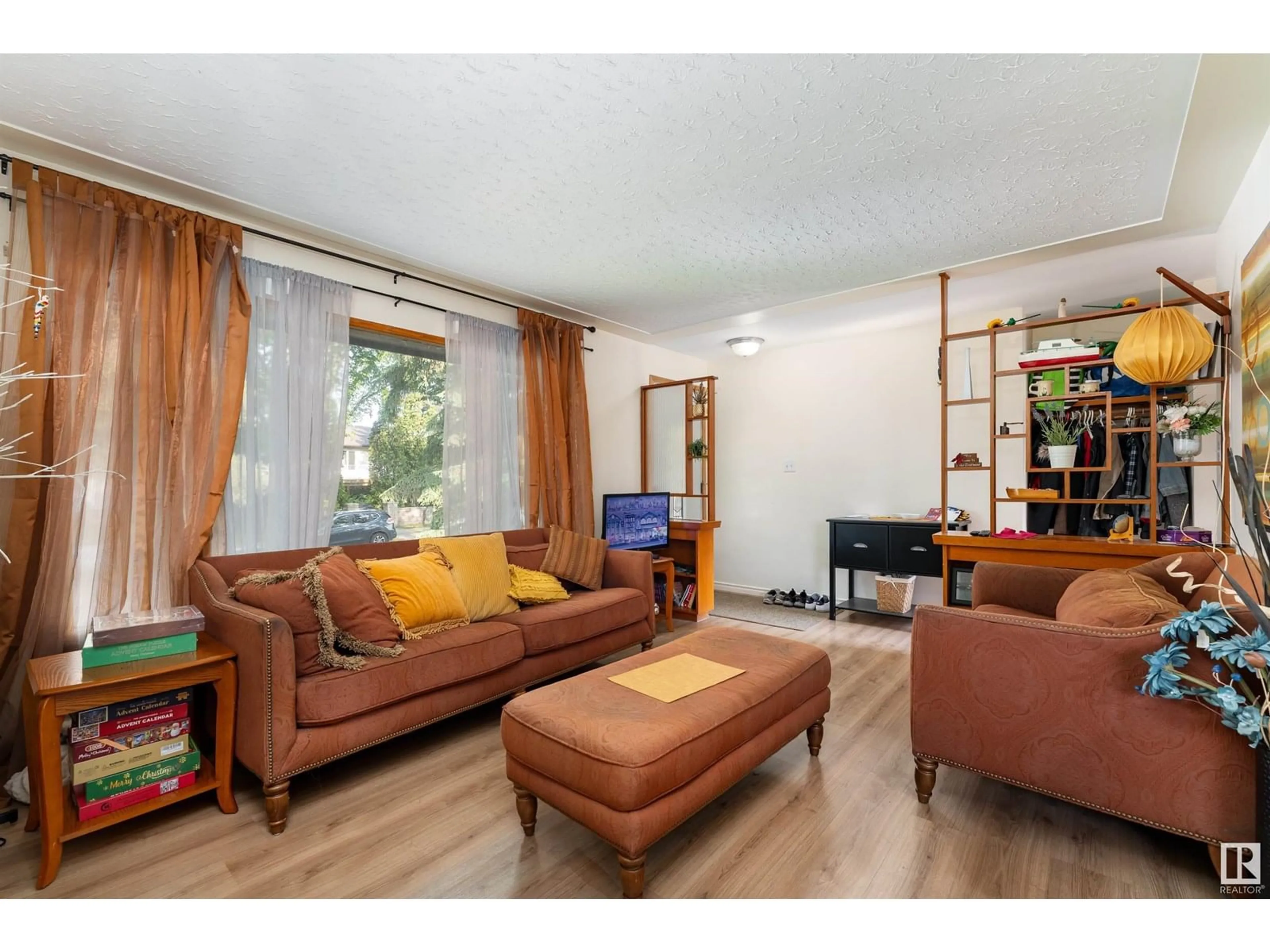 Living room with furniture, wood/laminate floor for 10421 - 10419 78 ST, Edmonton Alberta T6A3E7