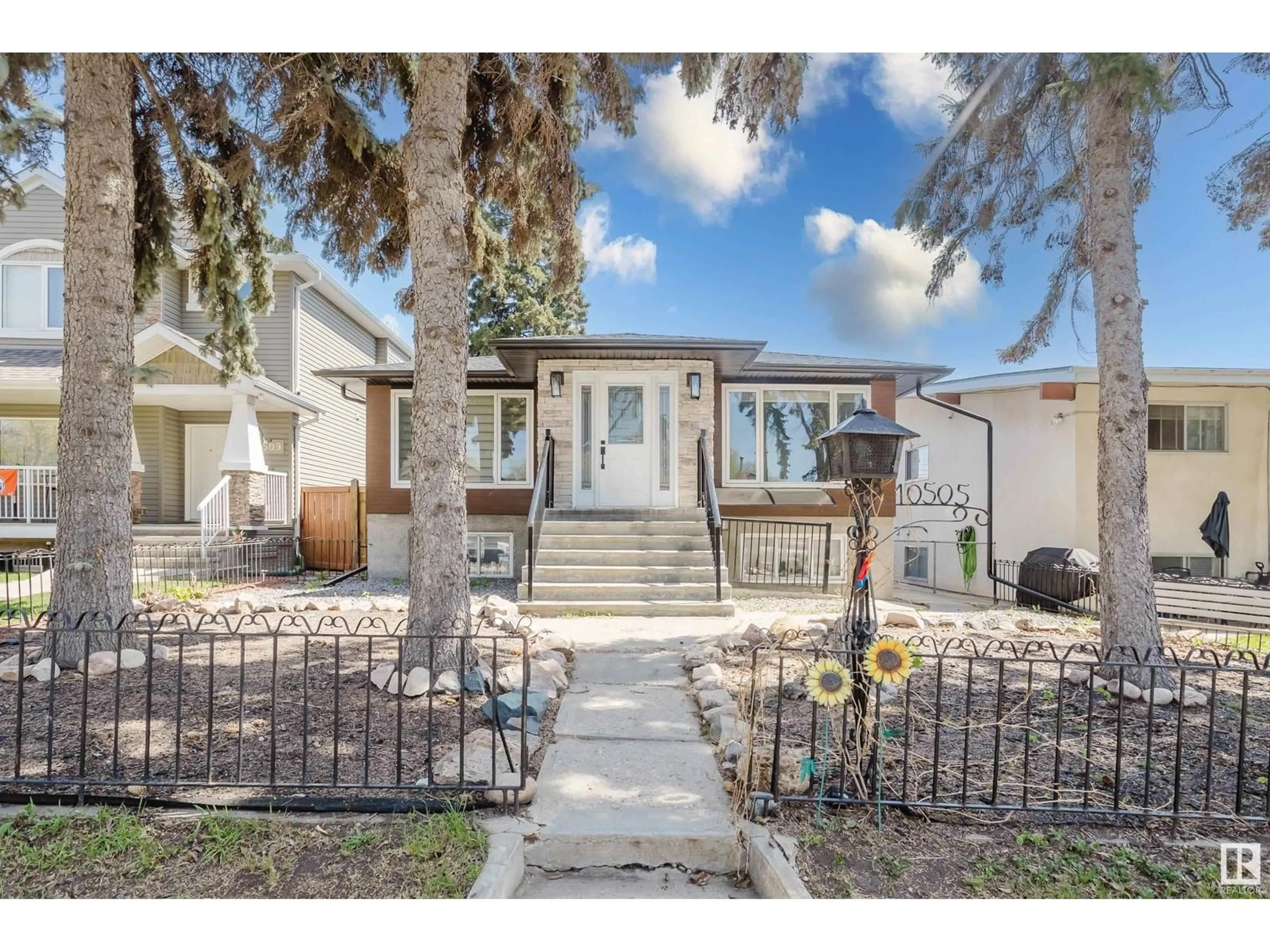 Home with vinyl exterior material, street for 10505 76 ST, Edmonton Alberta T6A3B2