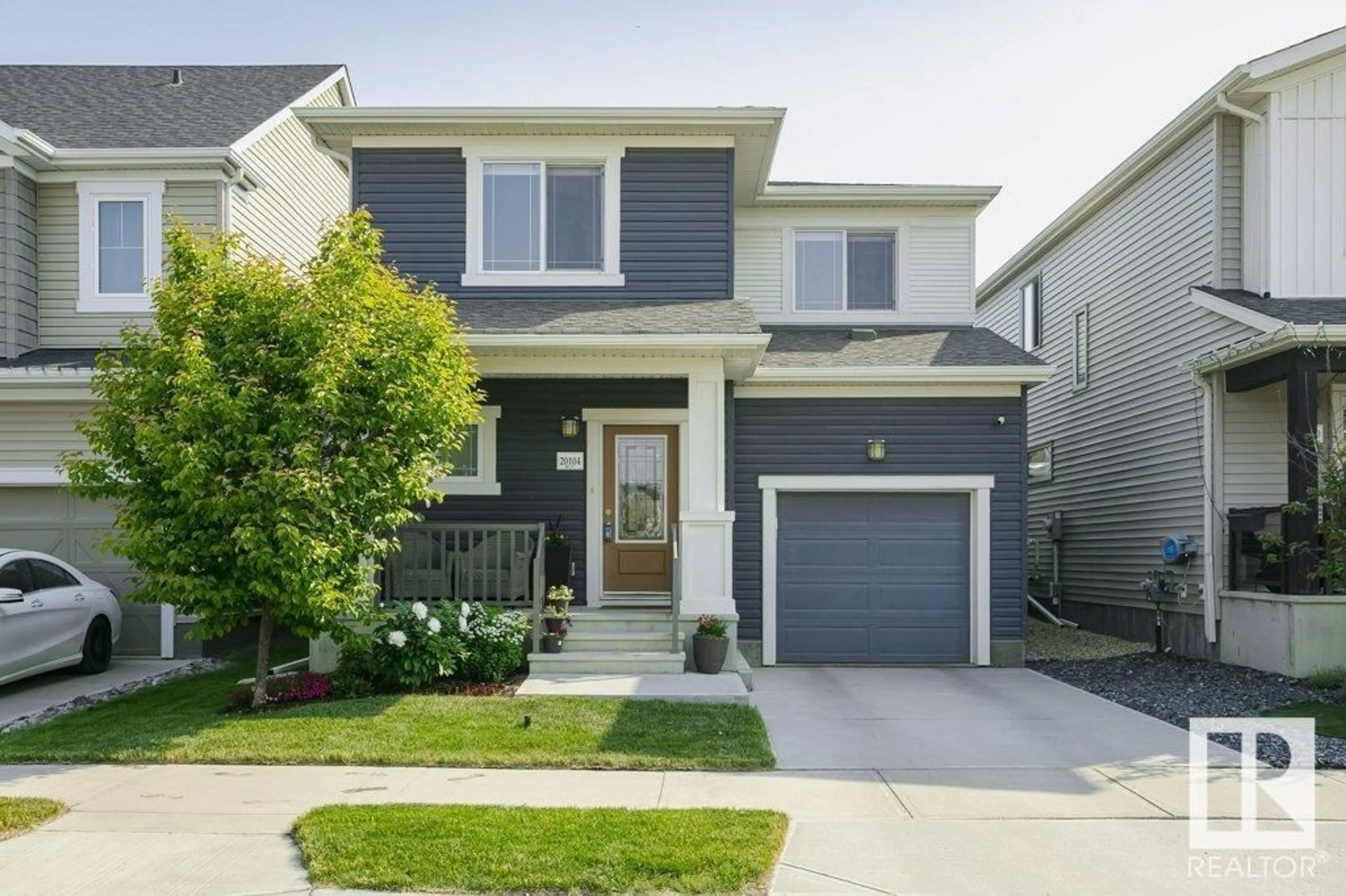 Home with vinyl exterior material, street for 20104 18 AV, Edmonton Alberta T6J4T9