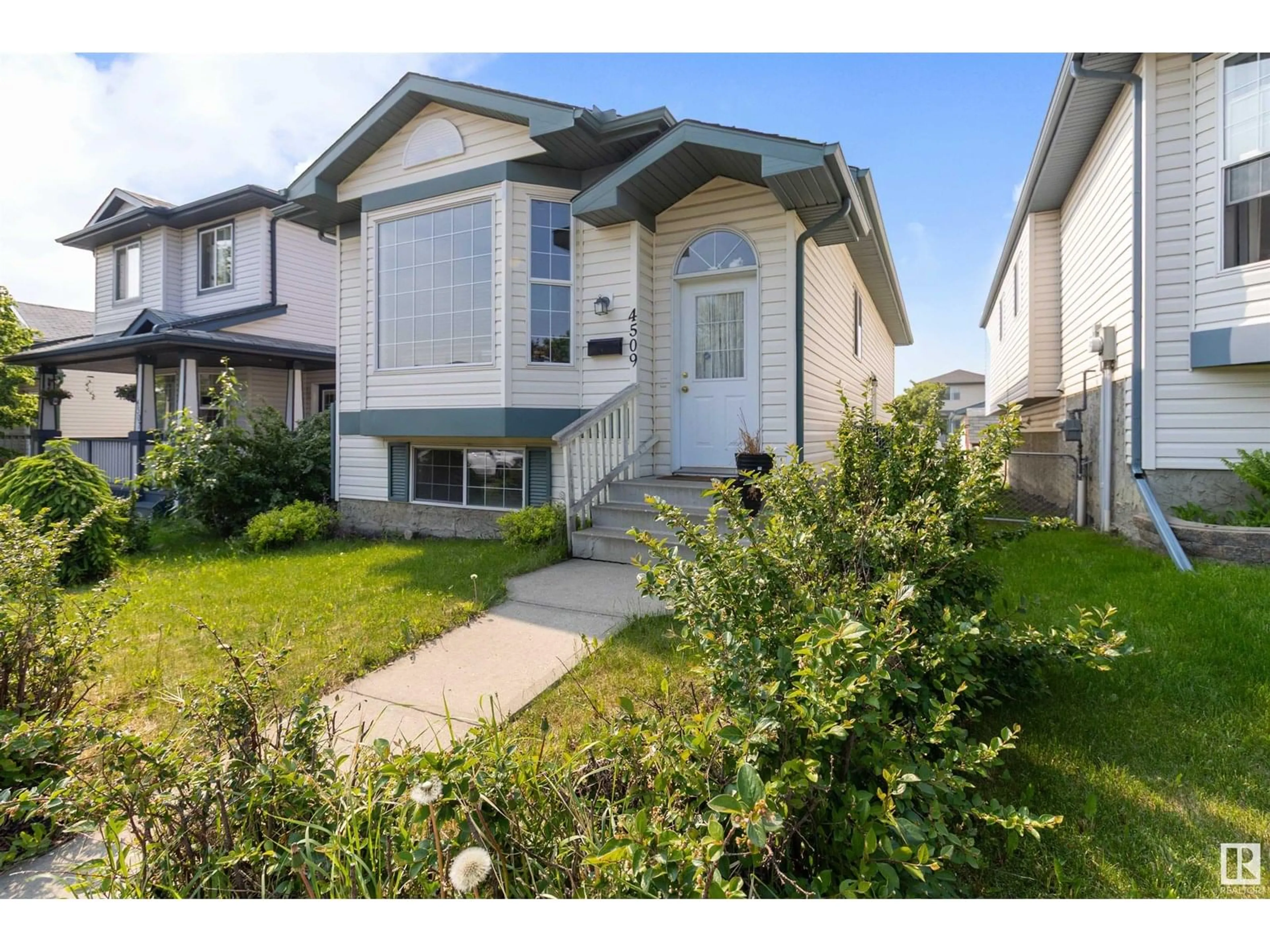 Home with vinyl exterior material, street for NW - 4509 150 AV, Edmonton Alberta T5Y2Z8