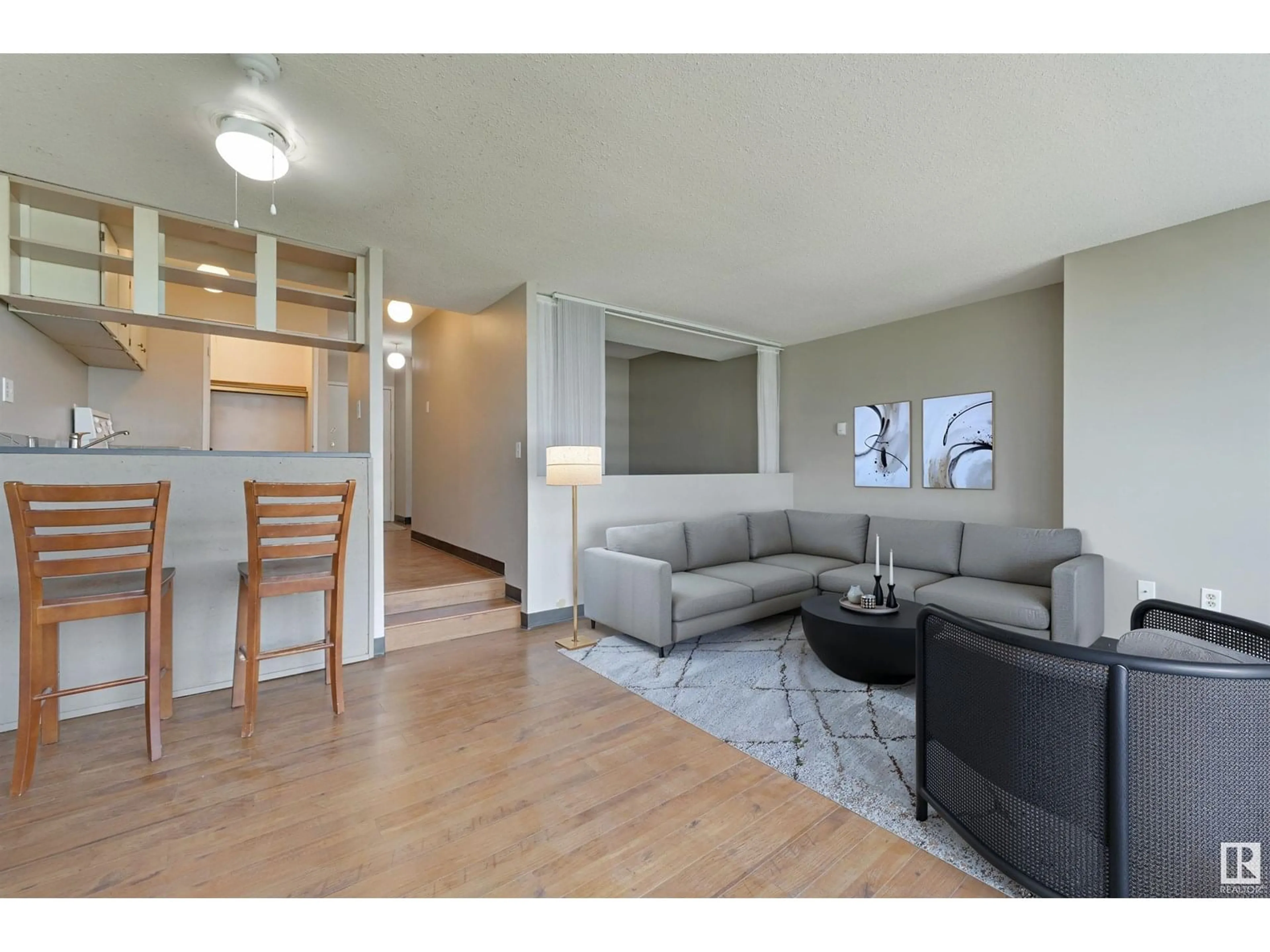 Living room with furniture, wood/laminate floor for 719 10160 114 ST NW, Edmonton Alberta T5K2L2
