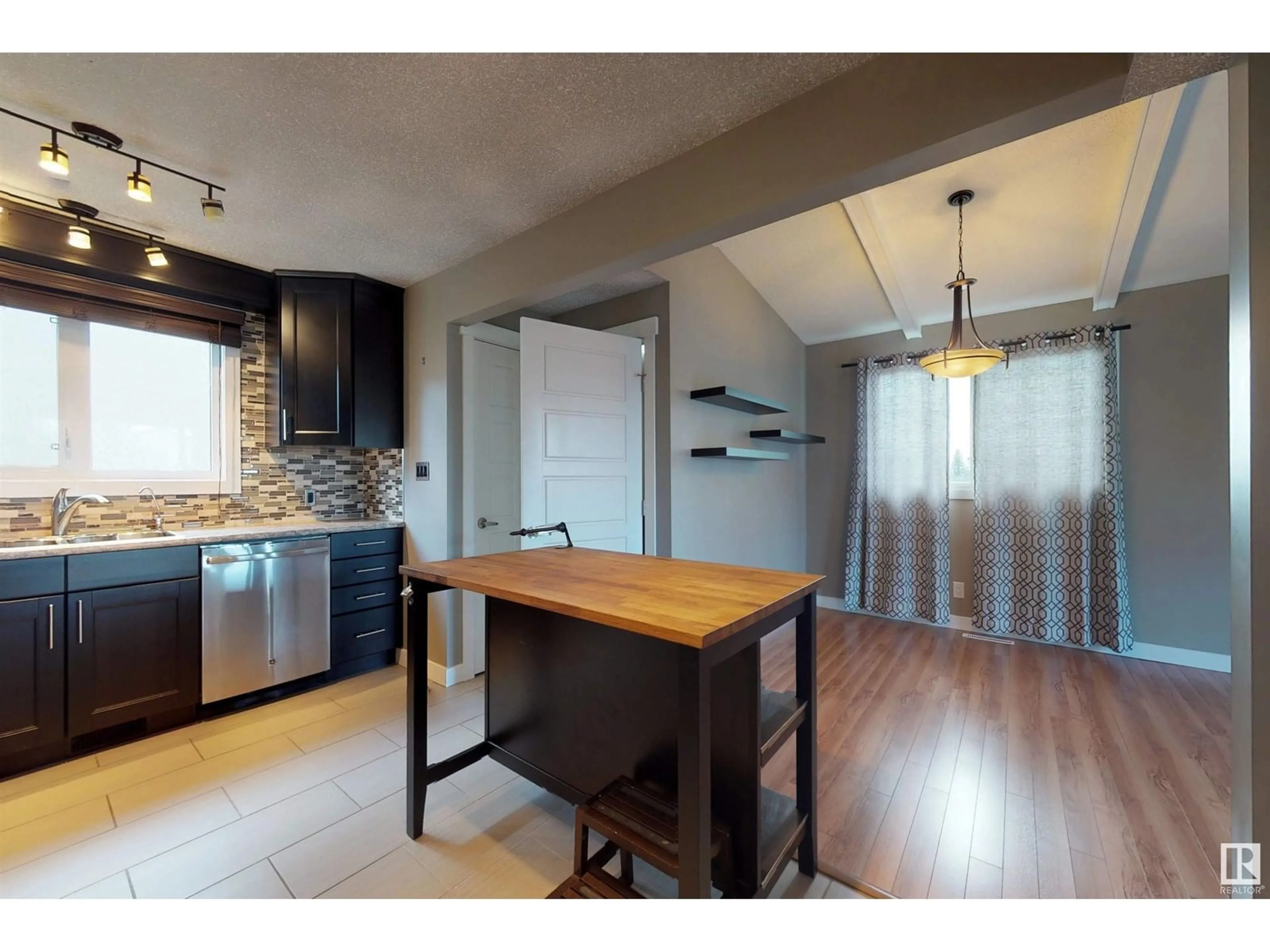Open concept kitchen, wood/laminate floor for 14703 75A ST NW, Edmonton Alberta T5C1A3