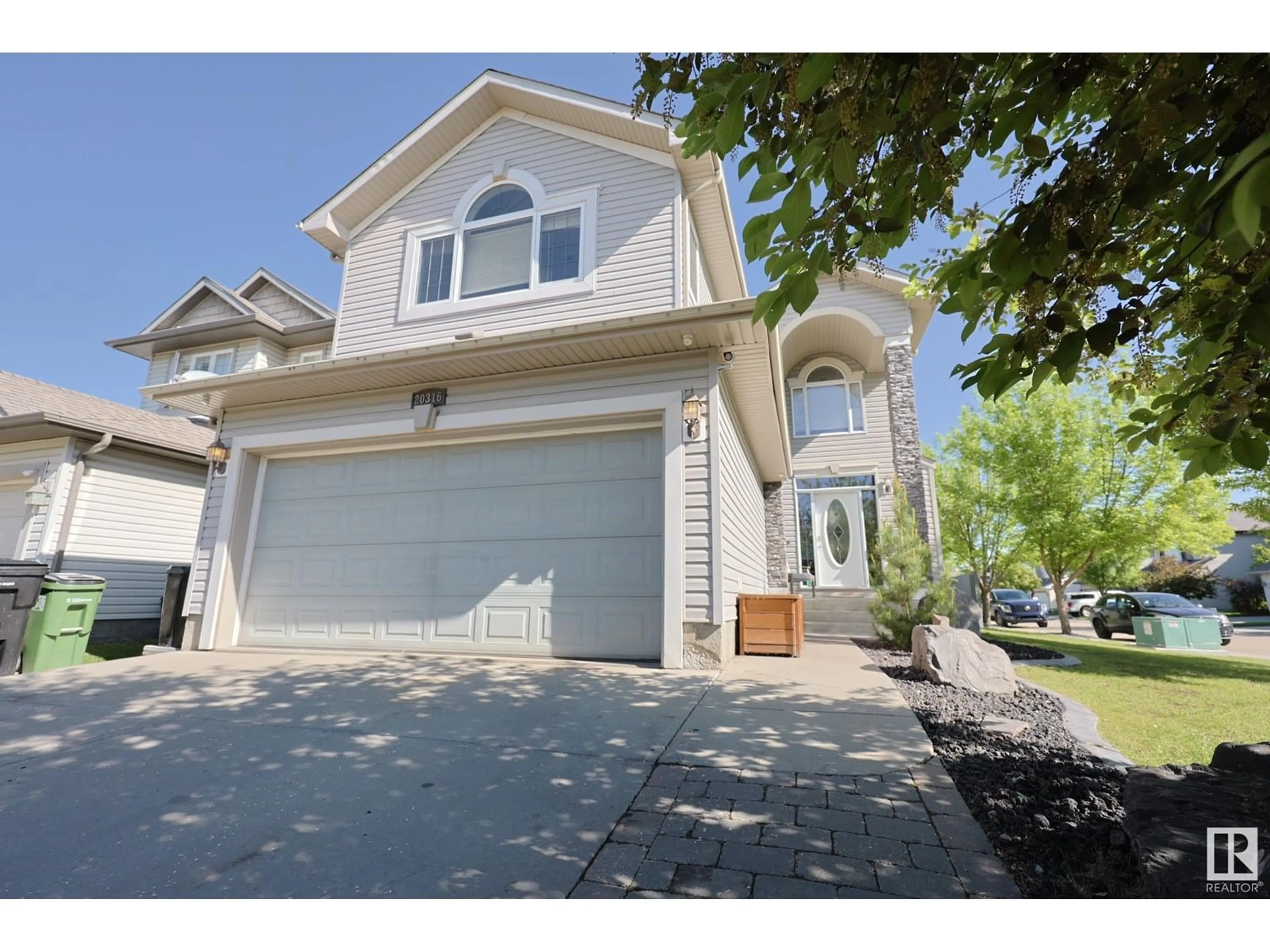 Home with vinyl exterior material, street for NW - 20316 46 AV, Edmonton Alberta T6M0A7