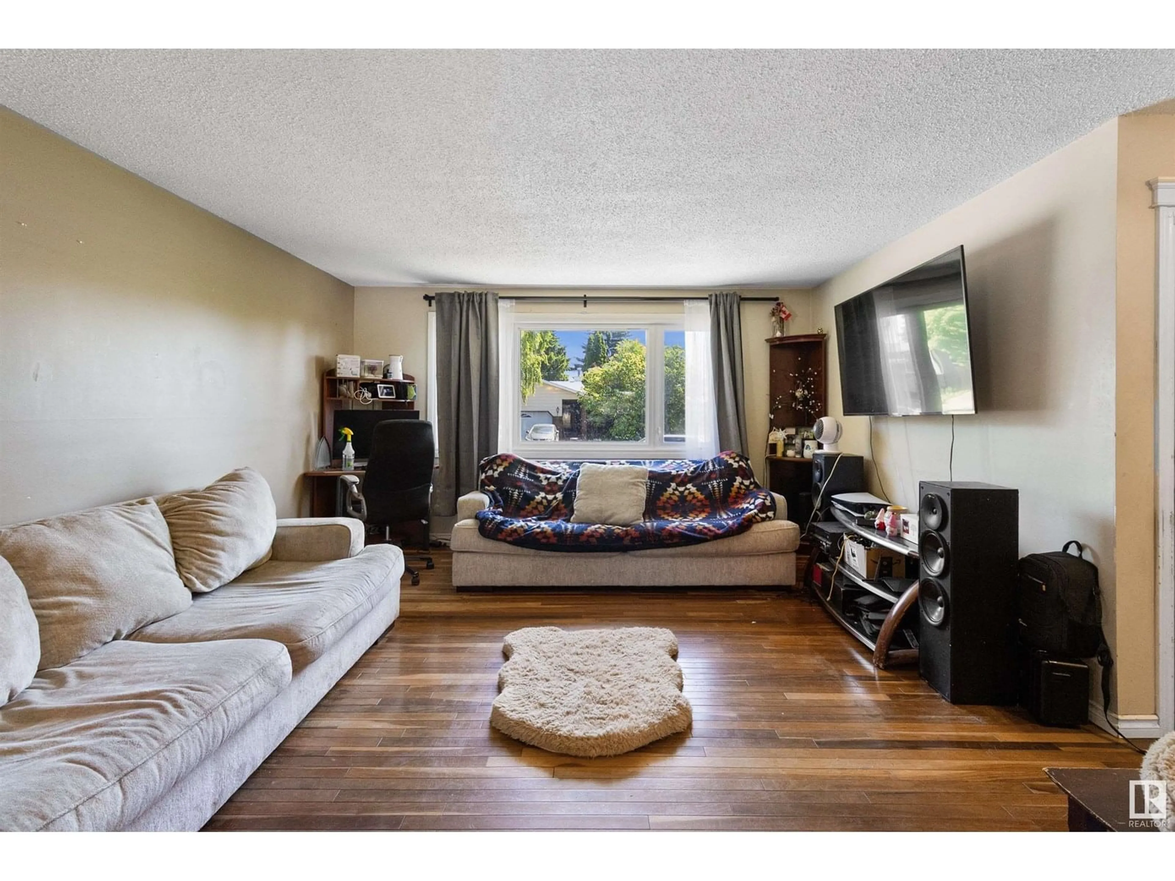 Living room with furniture, wood/laminate floor for 232 HUMBERSTONE RD, Edmonton Alberta T5A4C6