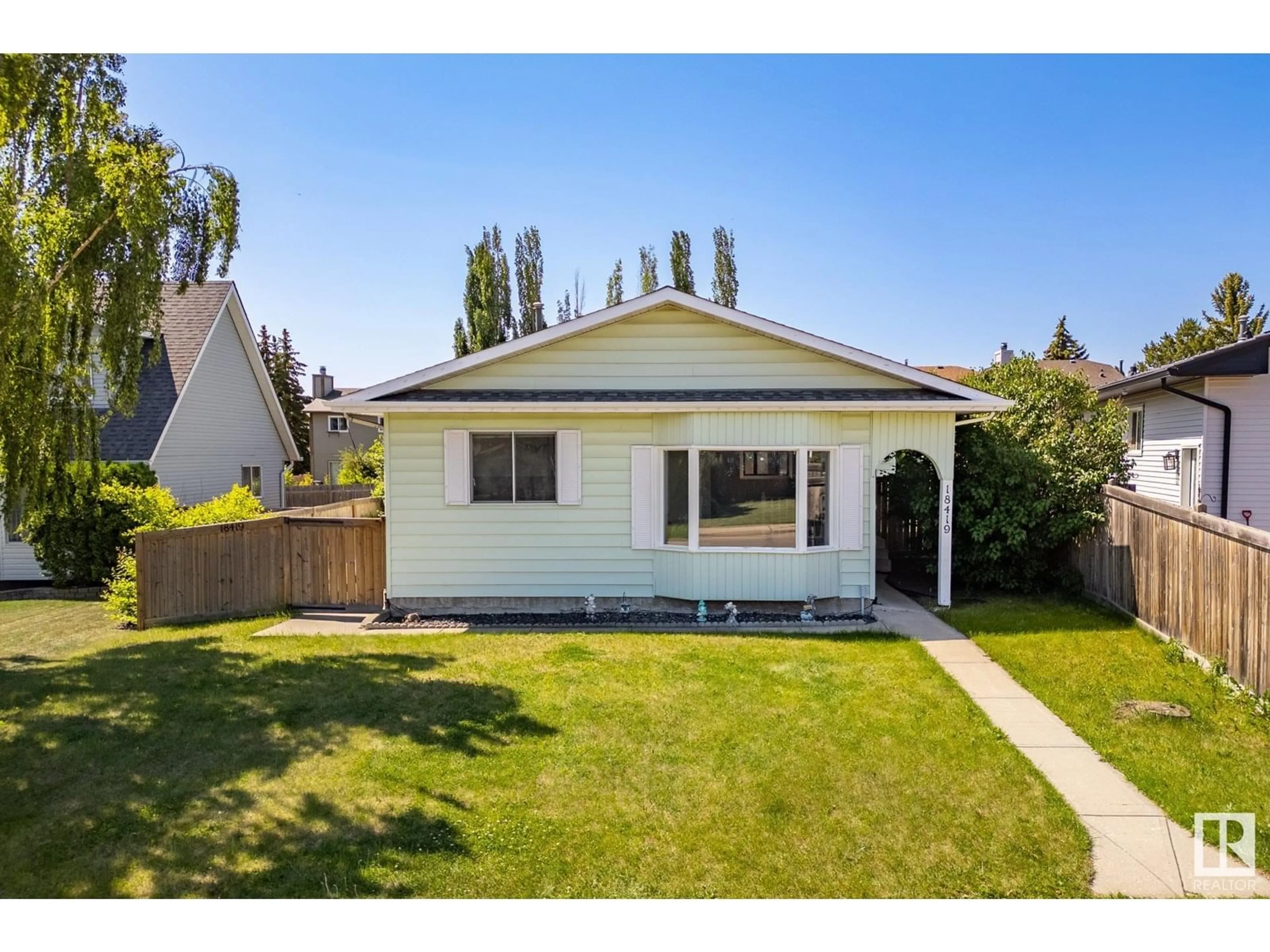 Home with vinyl exterior material, street for 18419 57 AV, Edmonton Alberta T6M1Y4
