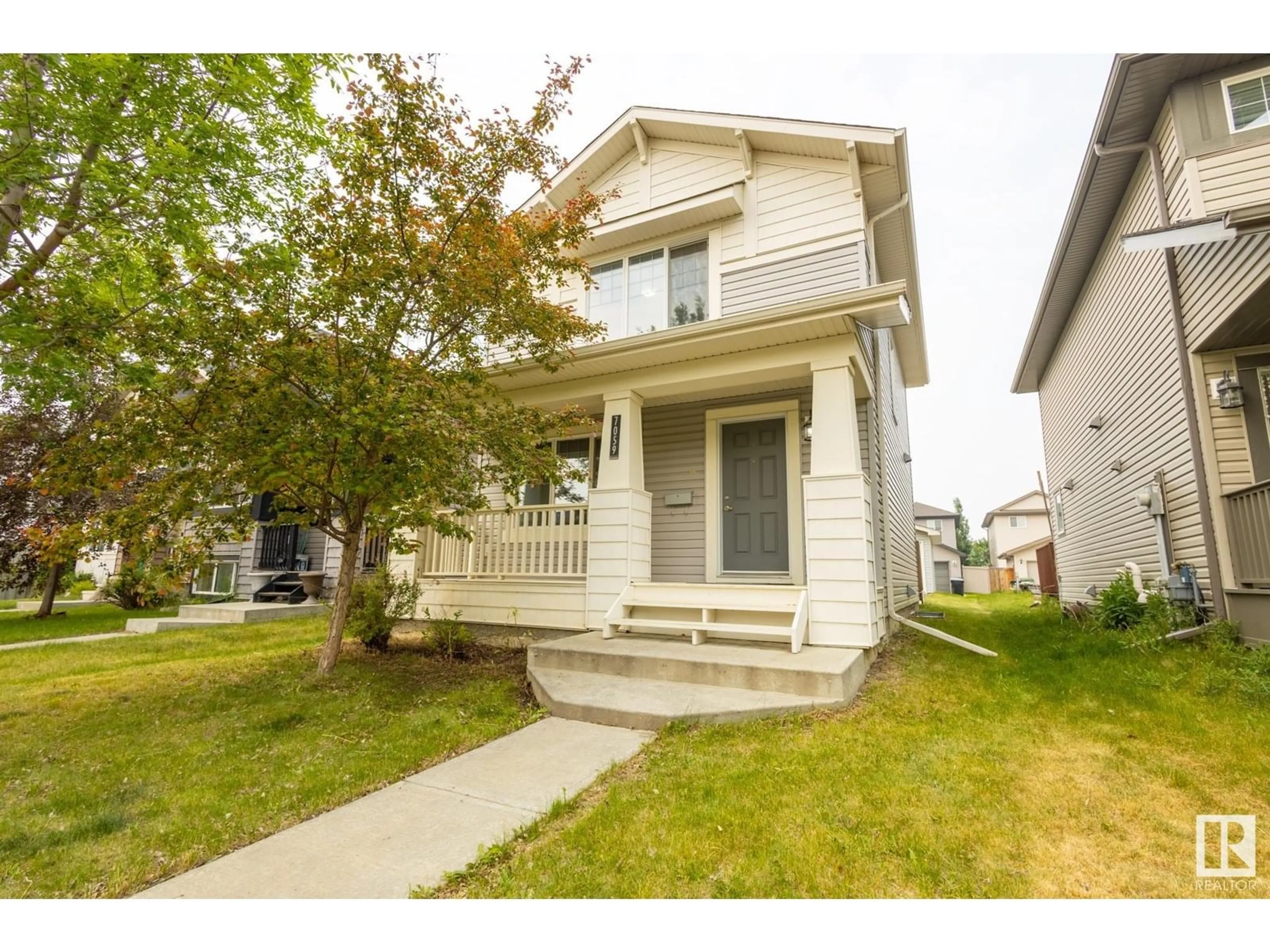 Home with vinyl exterior material, street for 7059 CARDINAL WY, Edmonton Alberta T6W1Z2