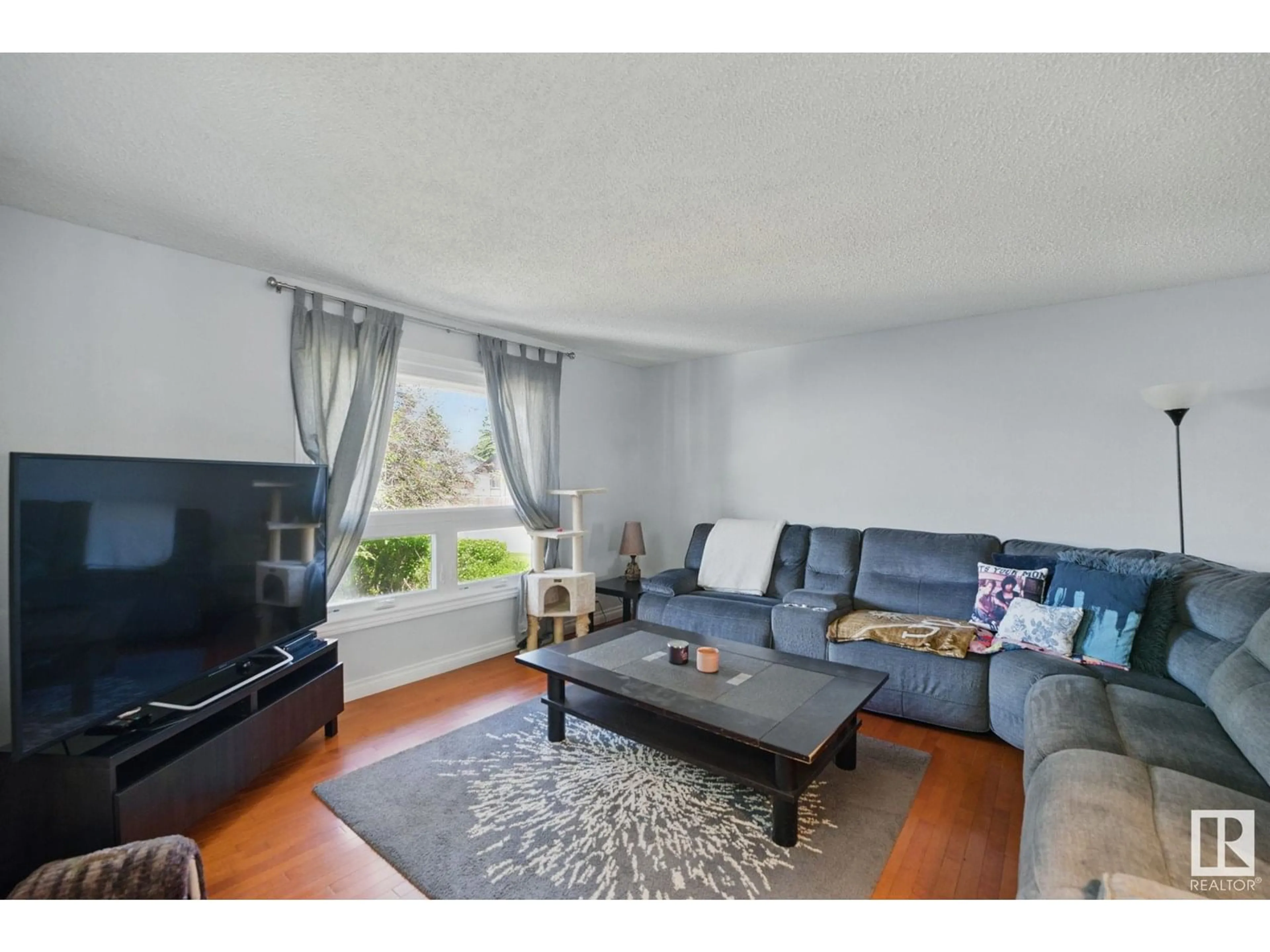 Living room with furniture, wood/laminate floor for 60 HOWSON CR, Edmonton Alberta T5A4T6