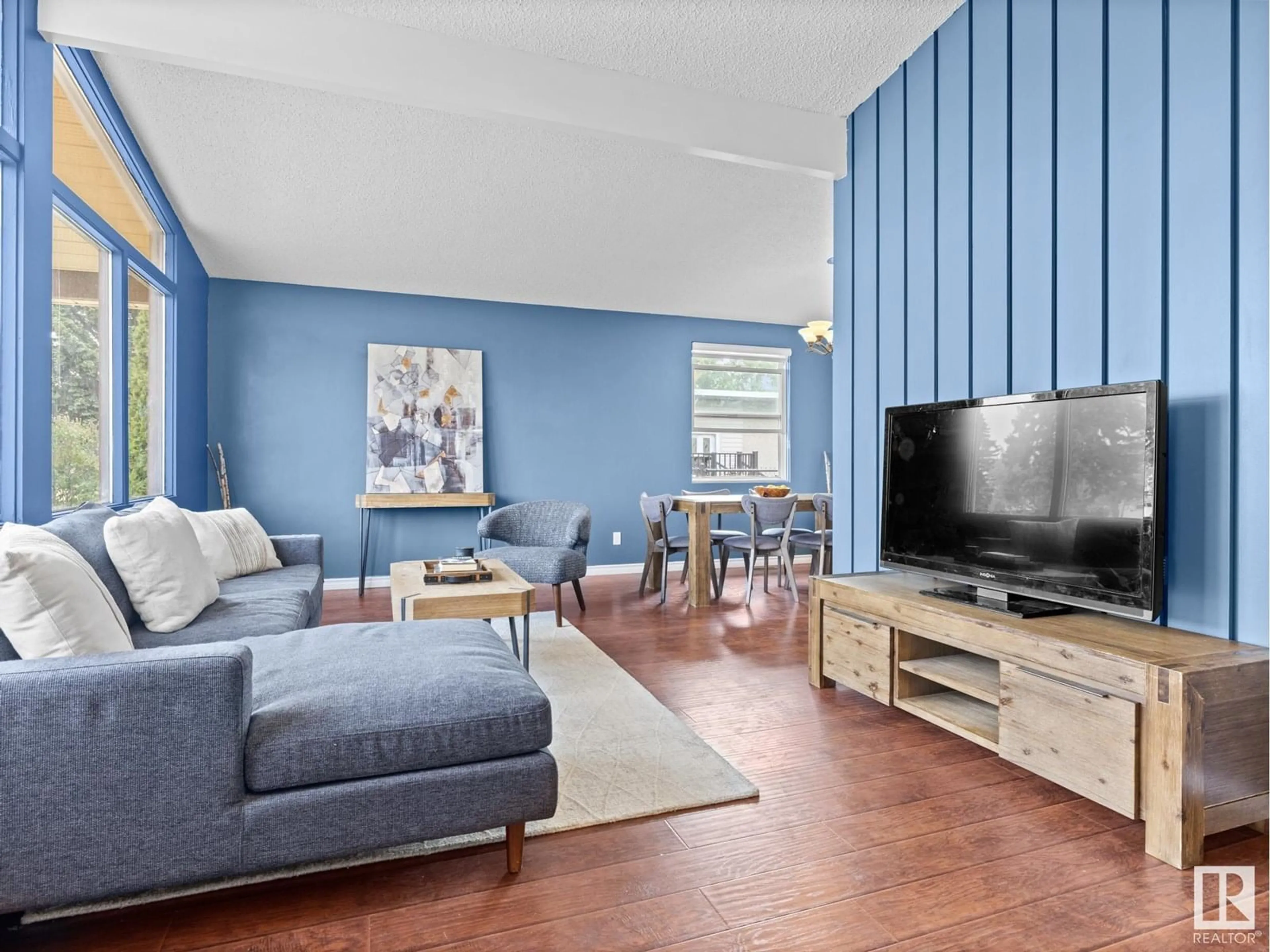 Living room with furniture, wood/laminate floor for NW - 13528 85A ST, Edmonton Alberta T5E3A5
