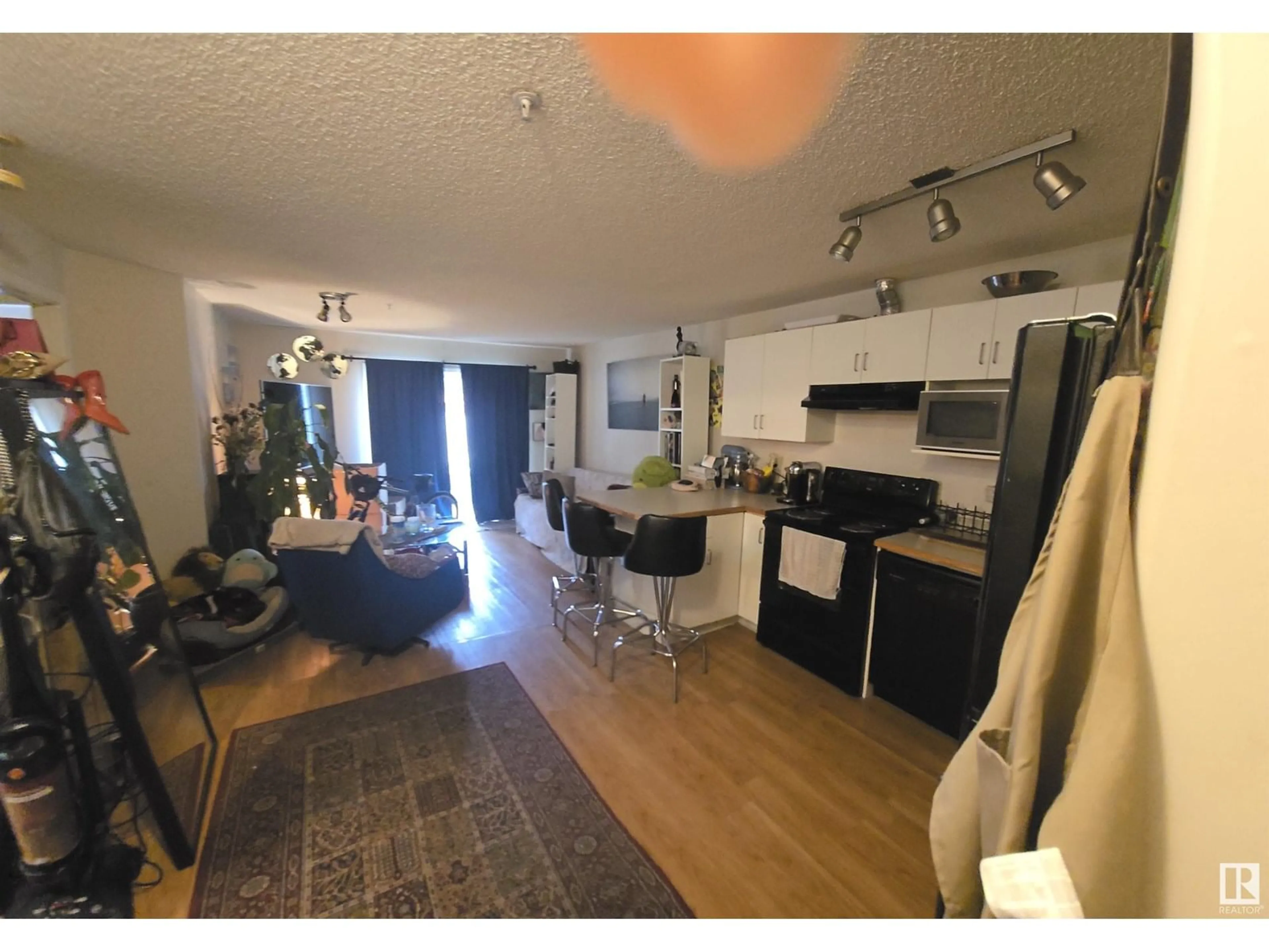 Open concept kitchen, wood/laminate floor for #103 - 10535 122 ST, Edmonton Alberta T5N4B7