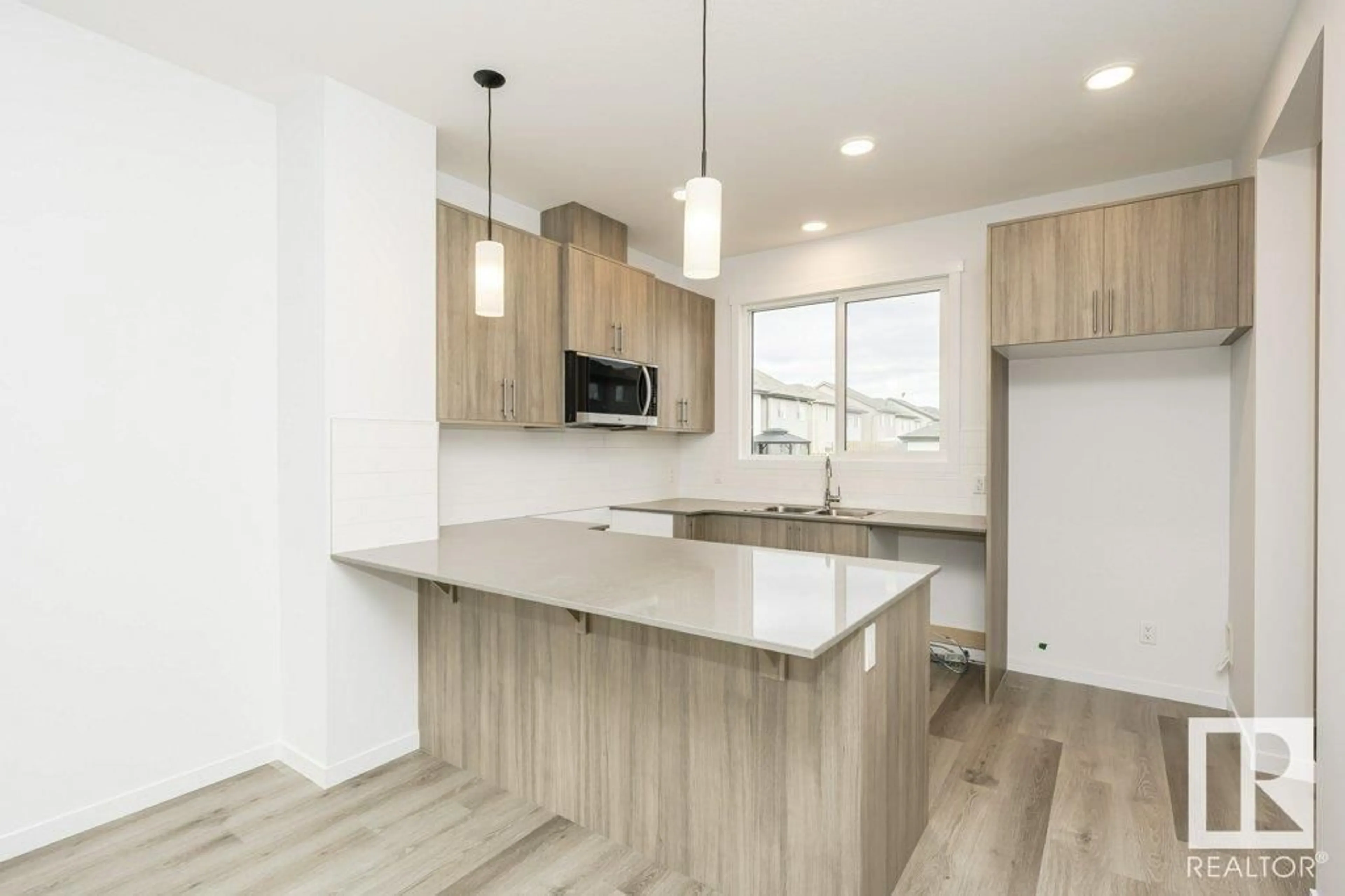 Open concept kitchen, wood/laminate floor for 6249 175A AV, Edmonton Alberta T5Y4A5