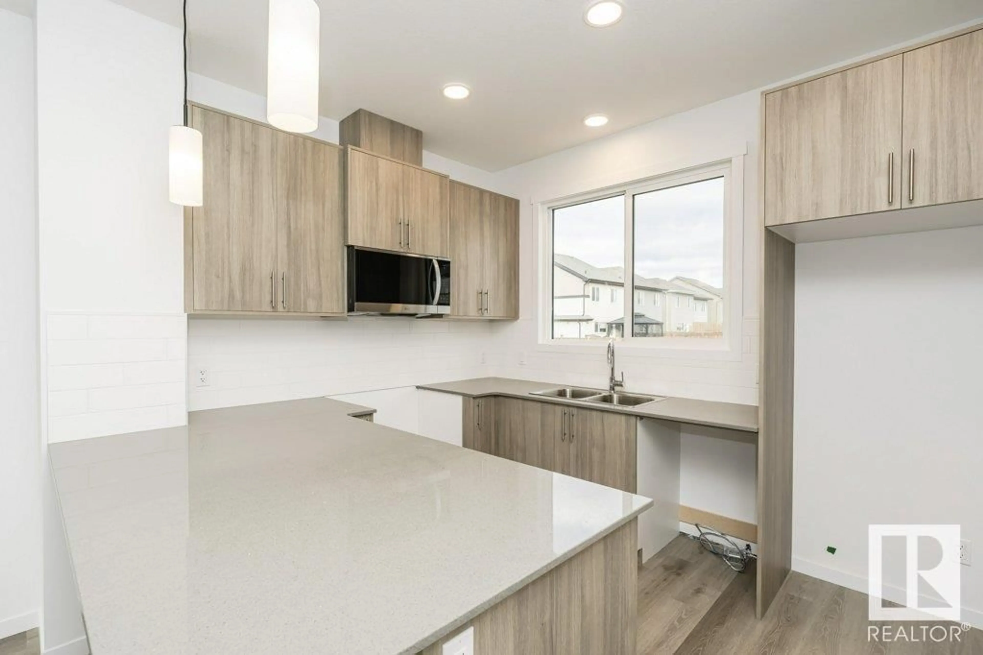 Open concept kitchen, wood/laminate floor for 6249 175A AV, Edmonton Alberta T5Y4A5