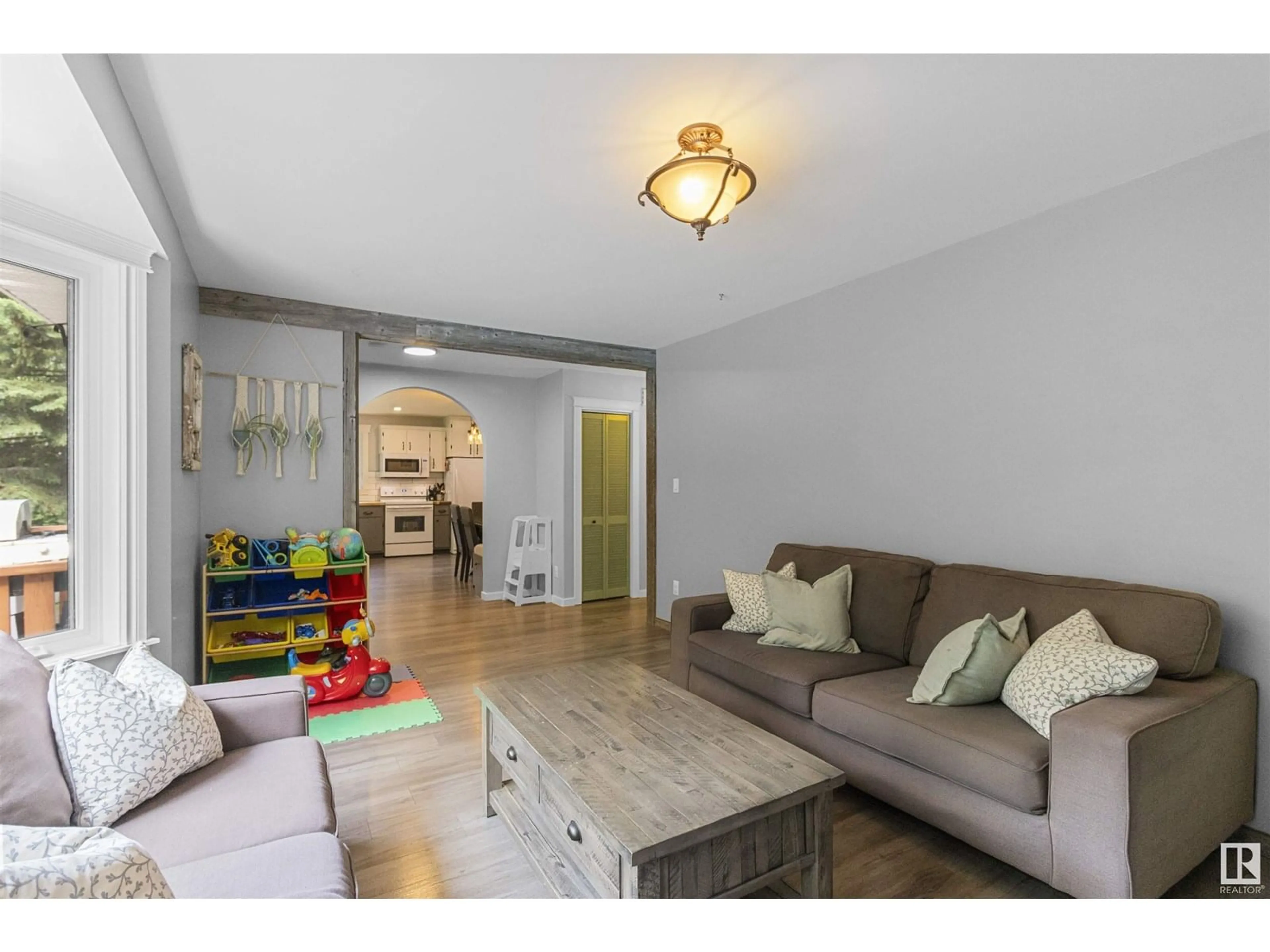 Living room with furniture, wood/laminate floor for 121 53347 RGE ROAD 215, Rural Strathcona County Alberta T8E2B2