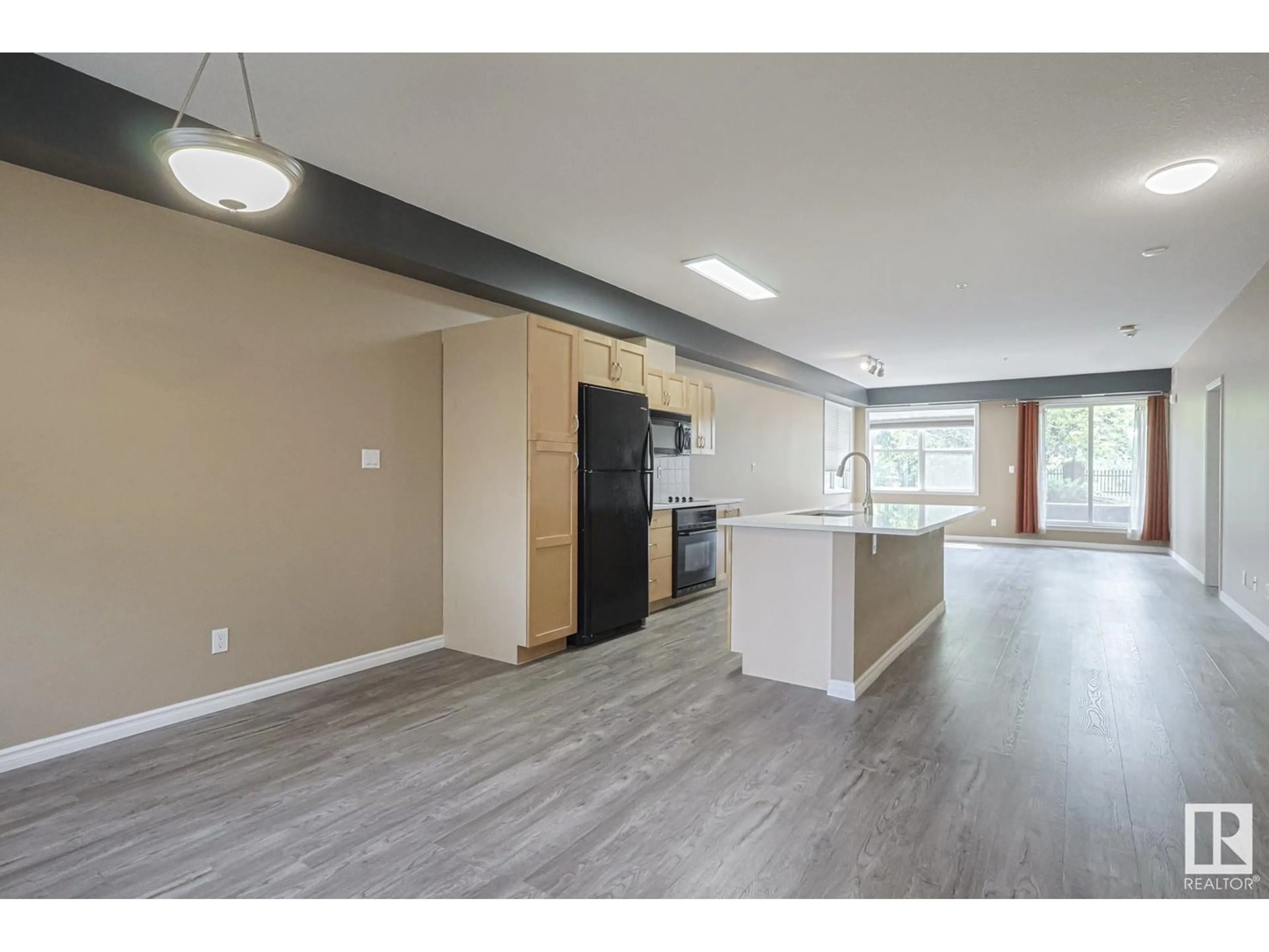 Open concept kitchen, wood/laminate floor for #113 - 9507 101 AV NW, Edmonton Alberta T5H4R1