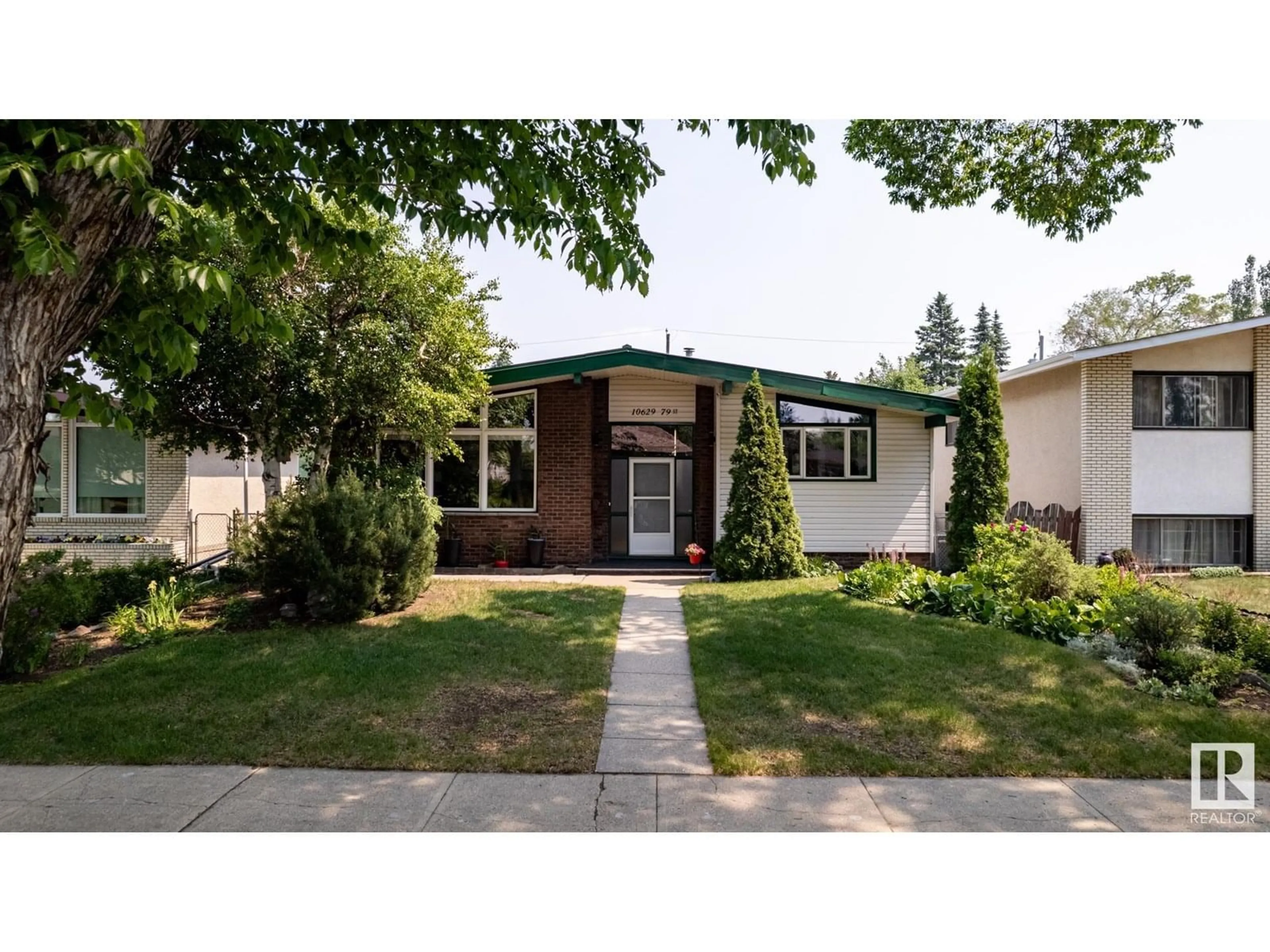 Home with vinyl exterior material, street for 10629 79 ST, Edmonton Alberta T6A3H5