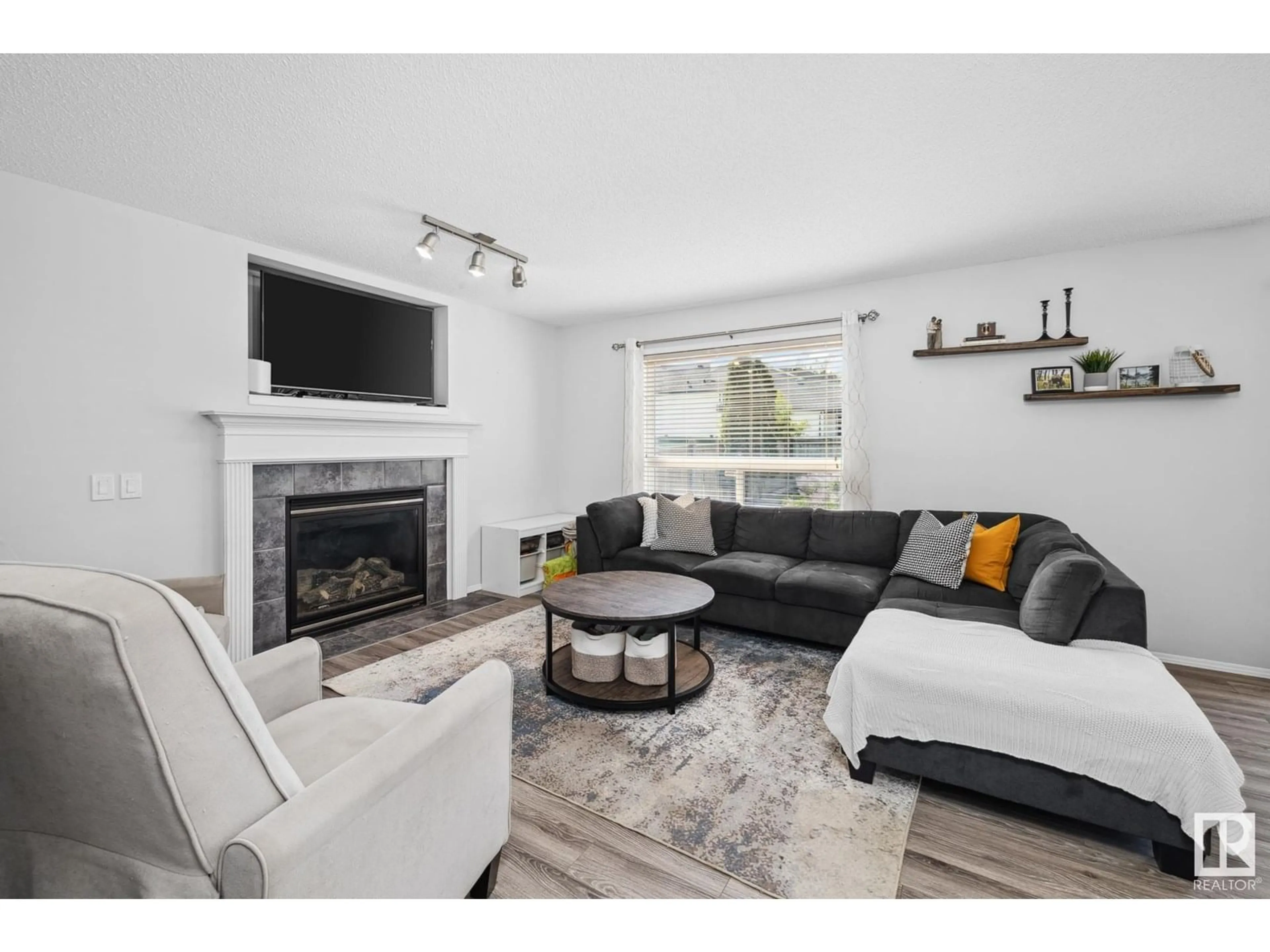 Living room with furniture, wood/laminate floor for NW - 9016 210 ST, Edmonton Alberta T5T6X1