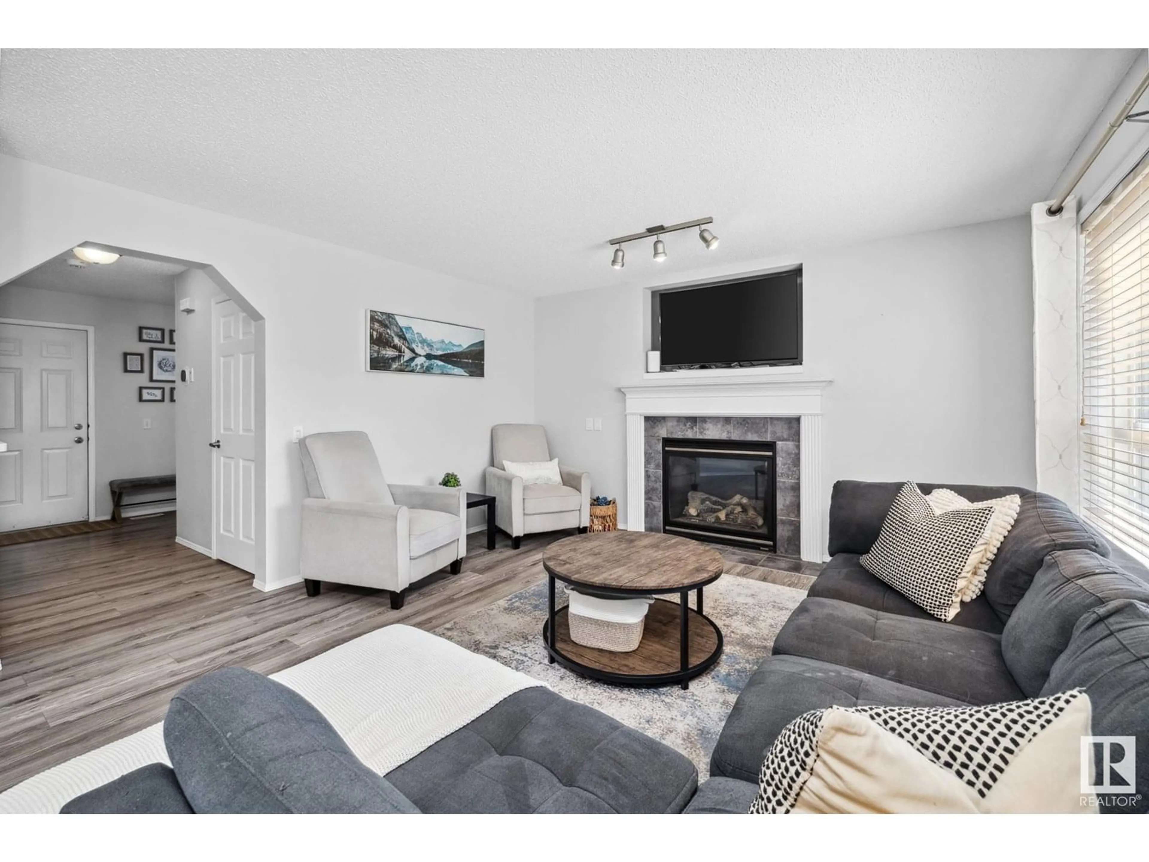 Living room with furniture, wood/laminate floor for NW - 9016 210 ST, Edmonton Alberta T5T6X1