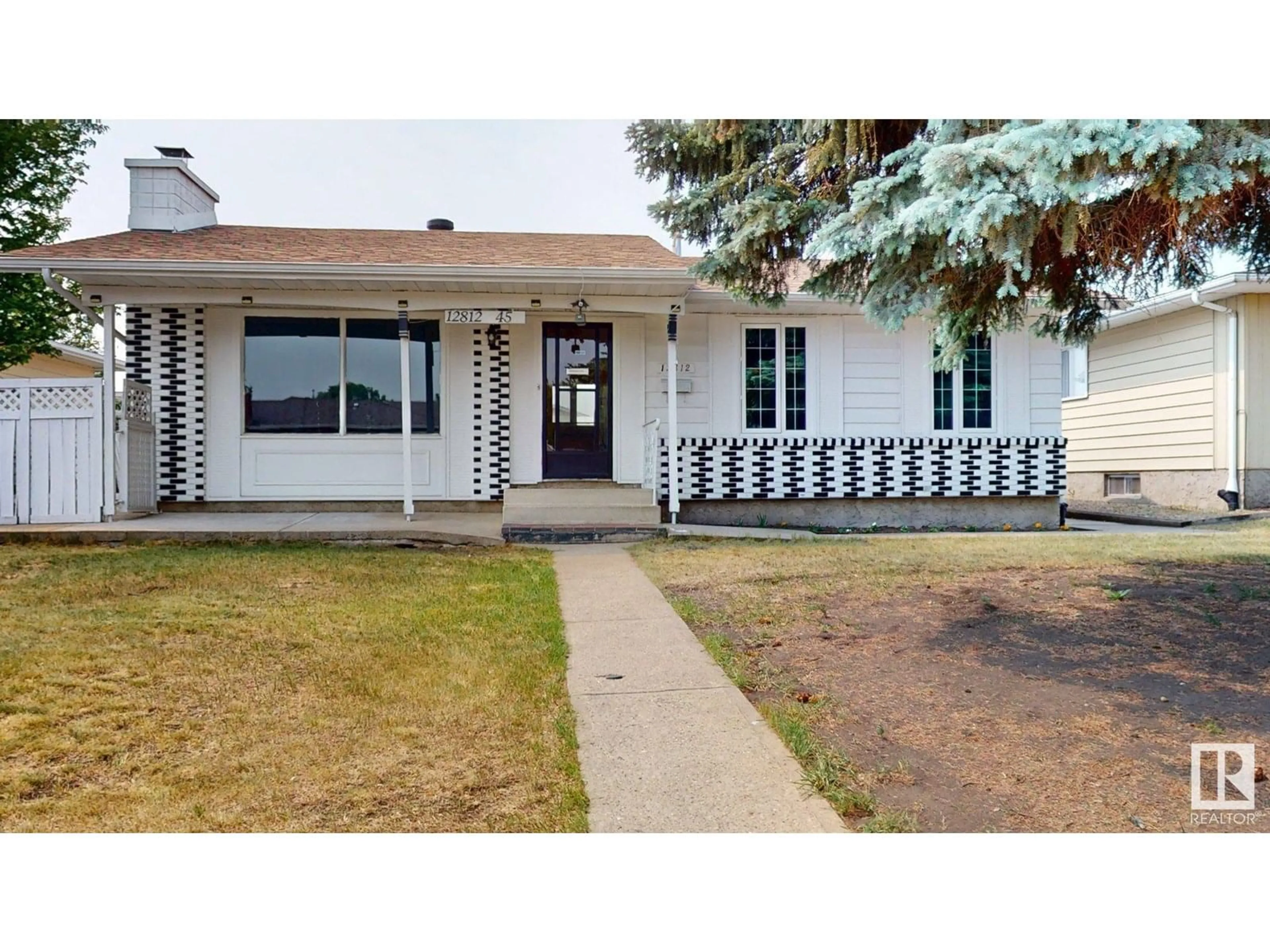 Home with vinyl exterior material, street for 12812 45 ST, Edmonton Alberta T5A2K4