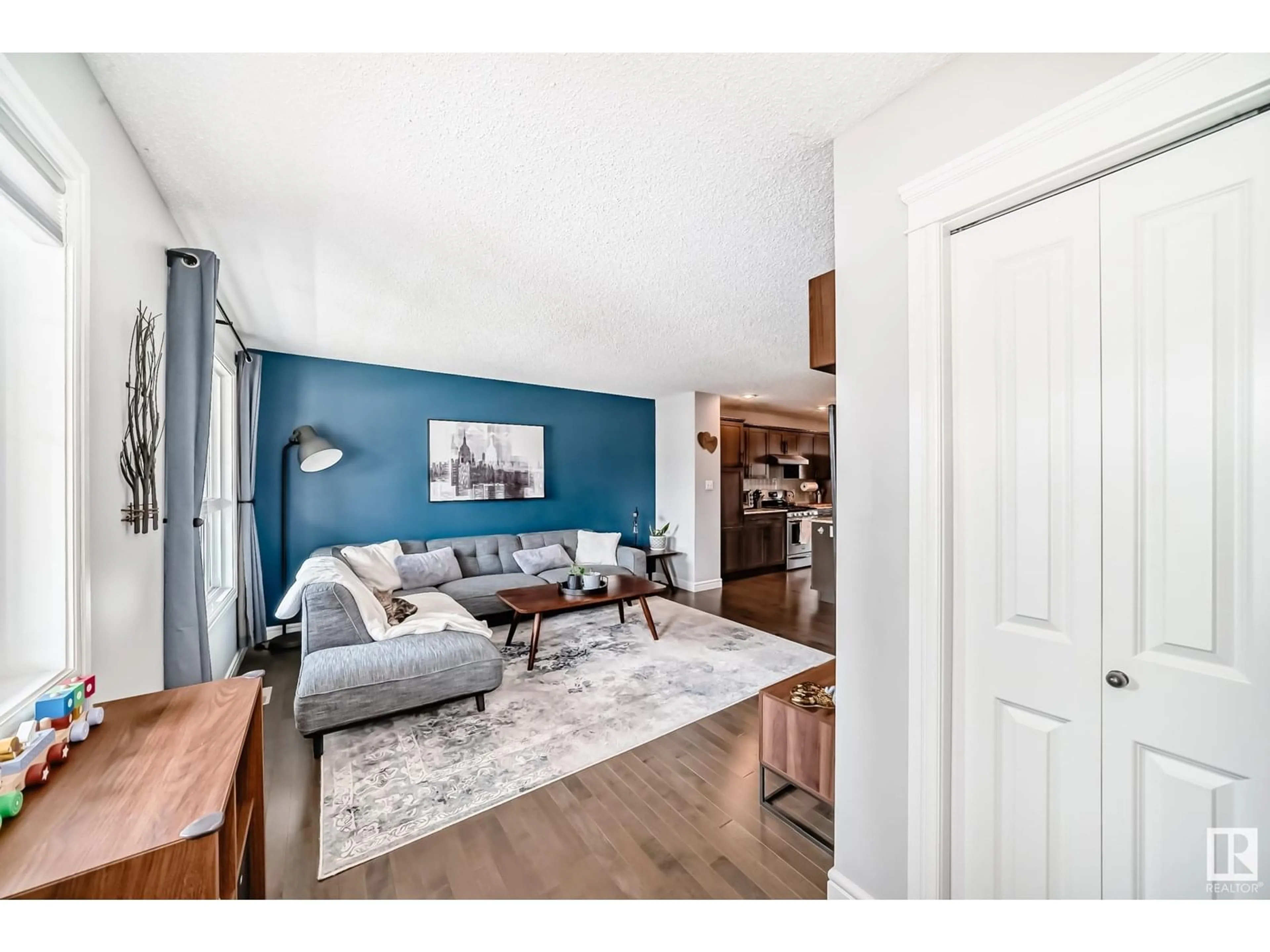 Living room with furniture, wood/laminate floor for 12240 173 AV, Edmonton Alberta T5X0K2