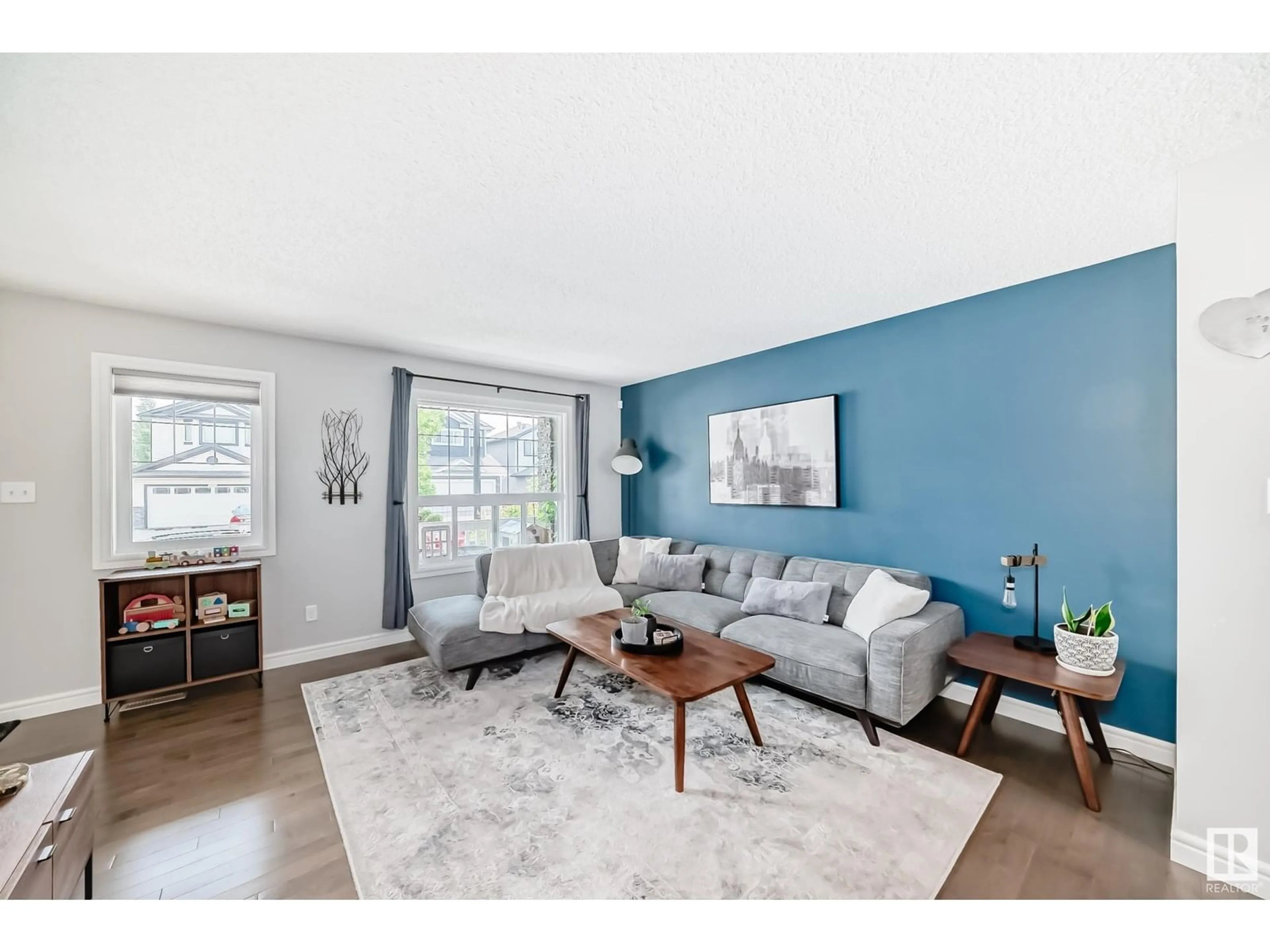 Living room with furniture, wood/laminate floor for 12240 173 AV, Edmonton Alberta T5X0K2