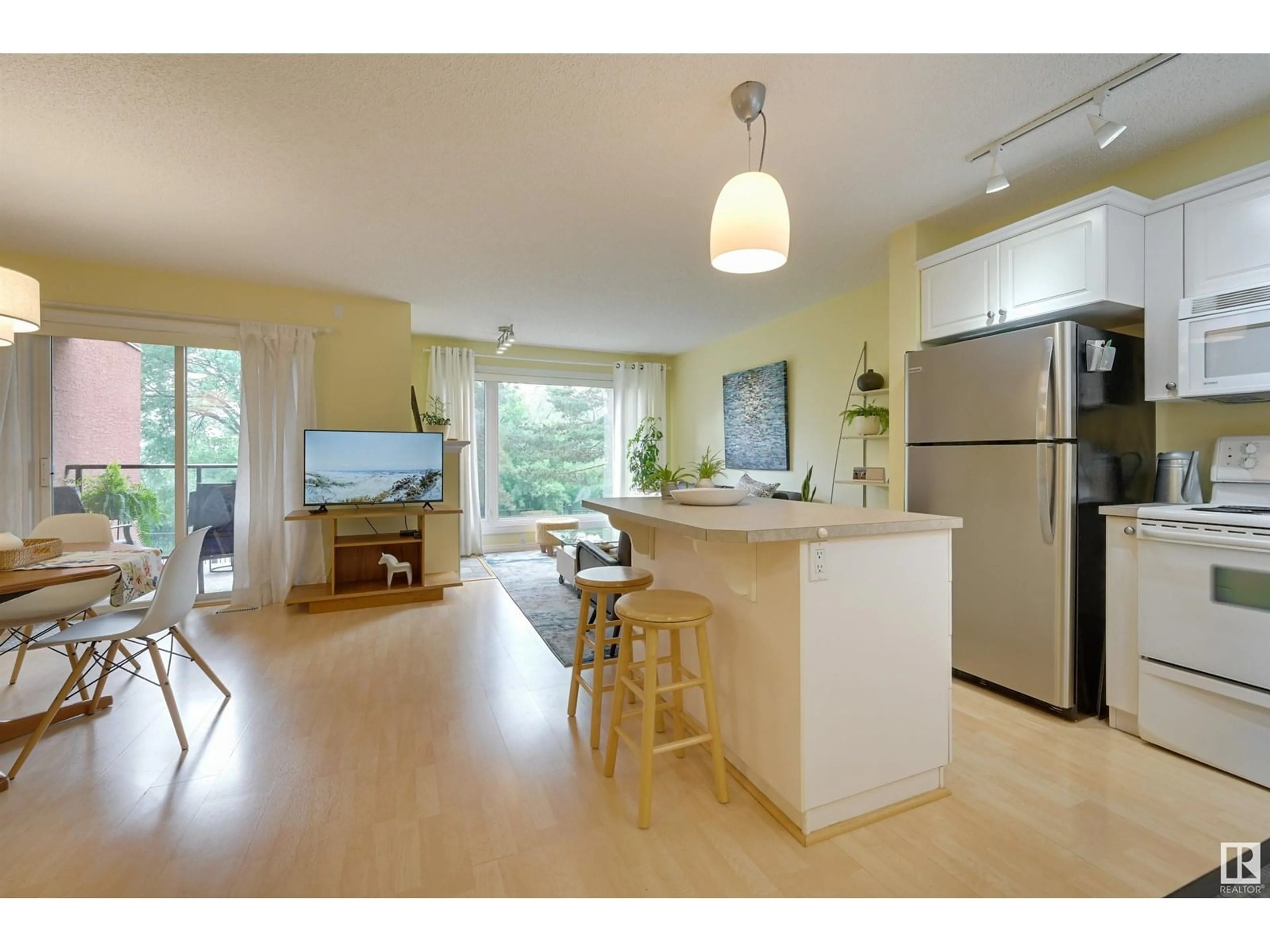 Open concept kitchen, wood/laminate floor for #104 - 10105 95 ST, Edmonton Alberta T5H4M4