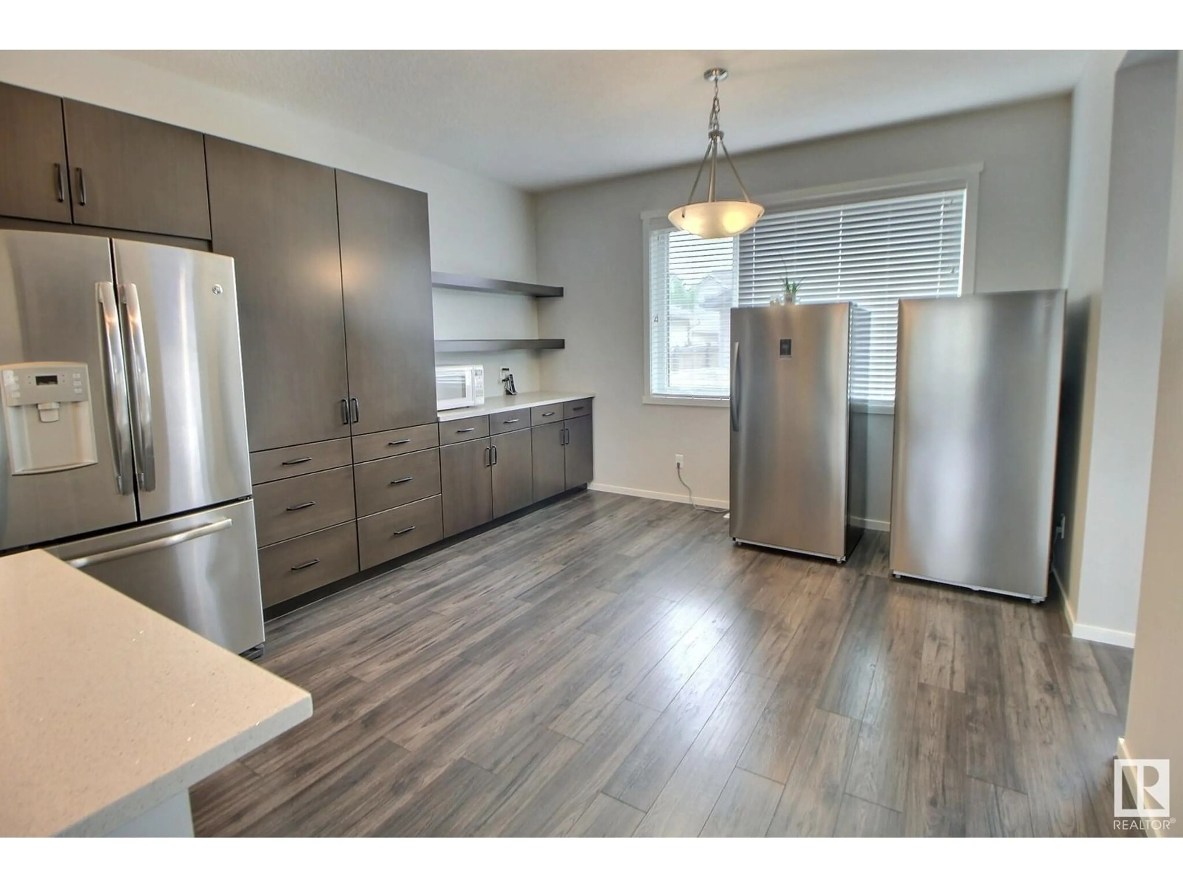 Open concept kitchen, wood/laminate floor for SW - 3456 CUTLER CR, Edmonton Alberta T6W2B3