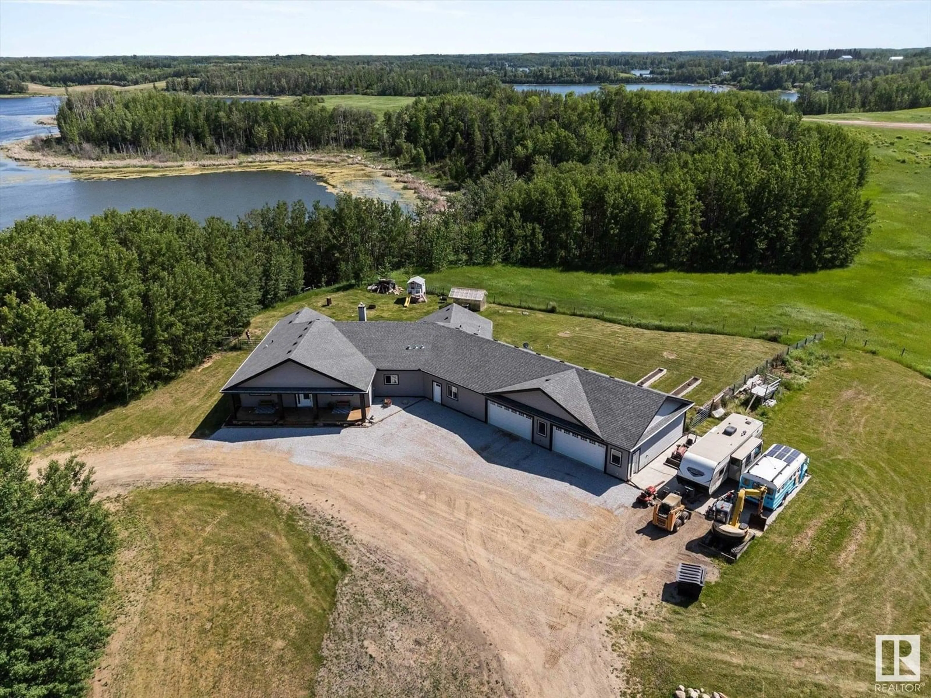 A pic from outside/outdoor area/front of a property/back of a property/a pic from drone, water/lake/river/ocean view for #21 - 2319 TWP ROAD 524, Rural Parkland County Alberta T7Y3M5