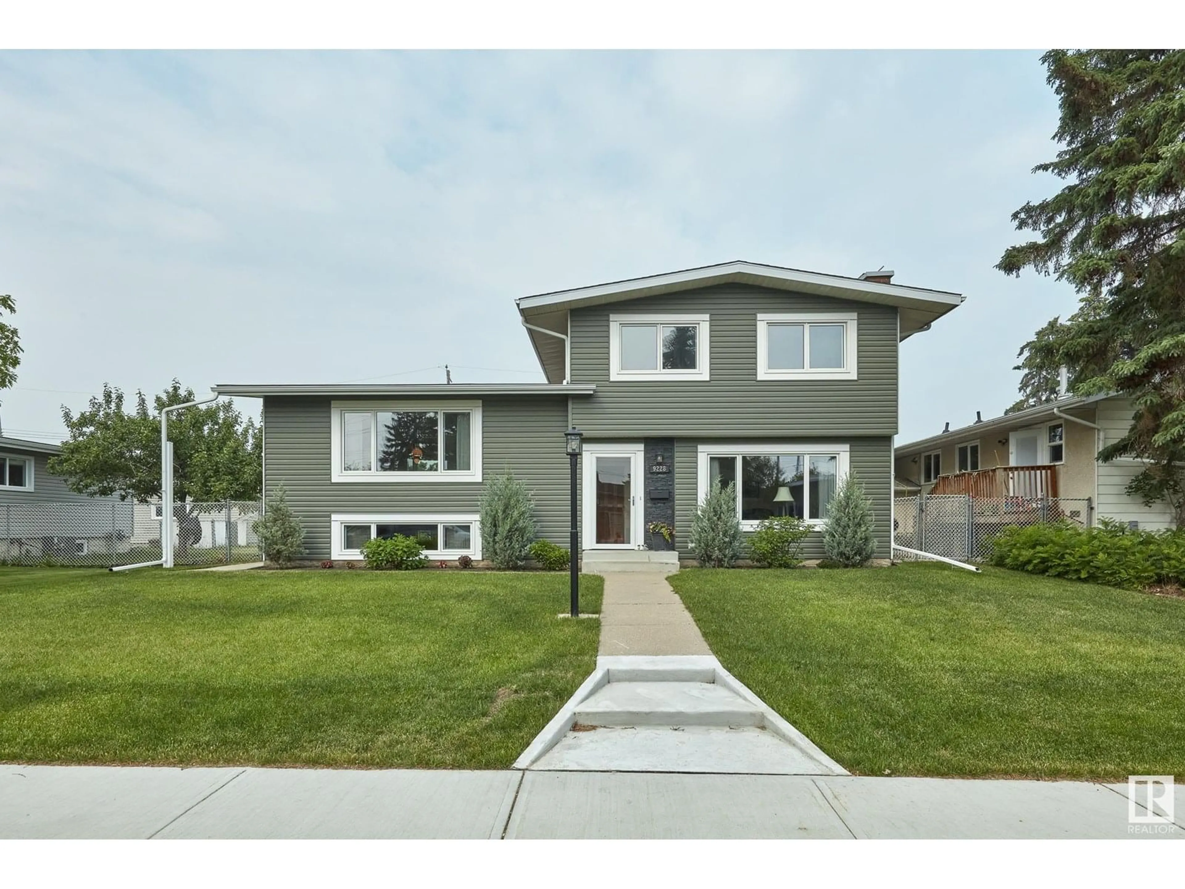 Home with vinyl exterior material, street for NW - 9228 52 ST, Edmonton Alberta T6B1G4