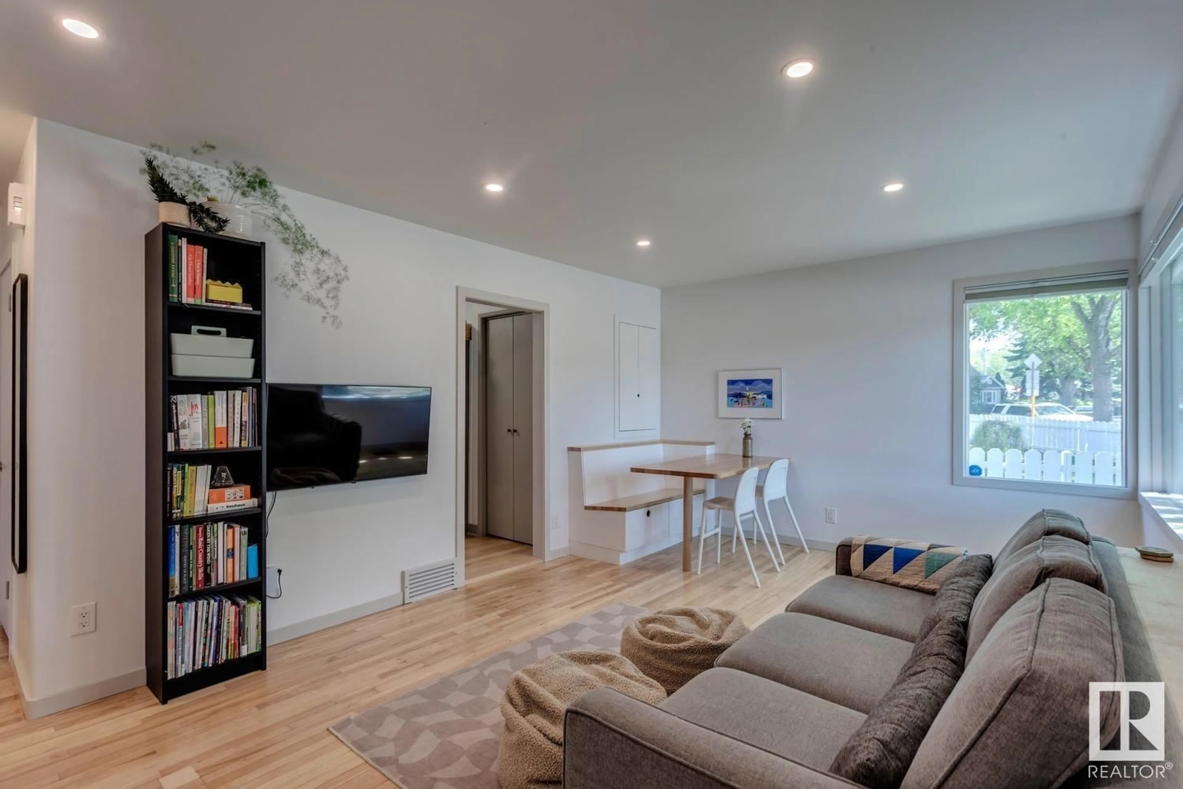 Living room with furniture, wood/laminate floor for NW - 5910 120 AV, Edmonton Alberta T5W1L6