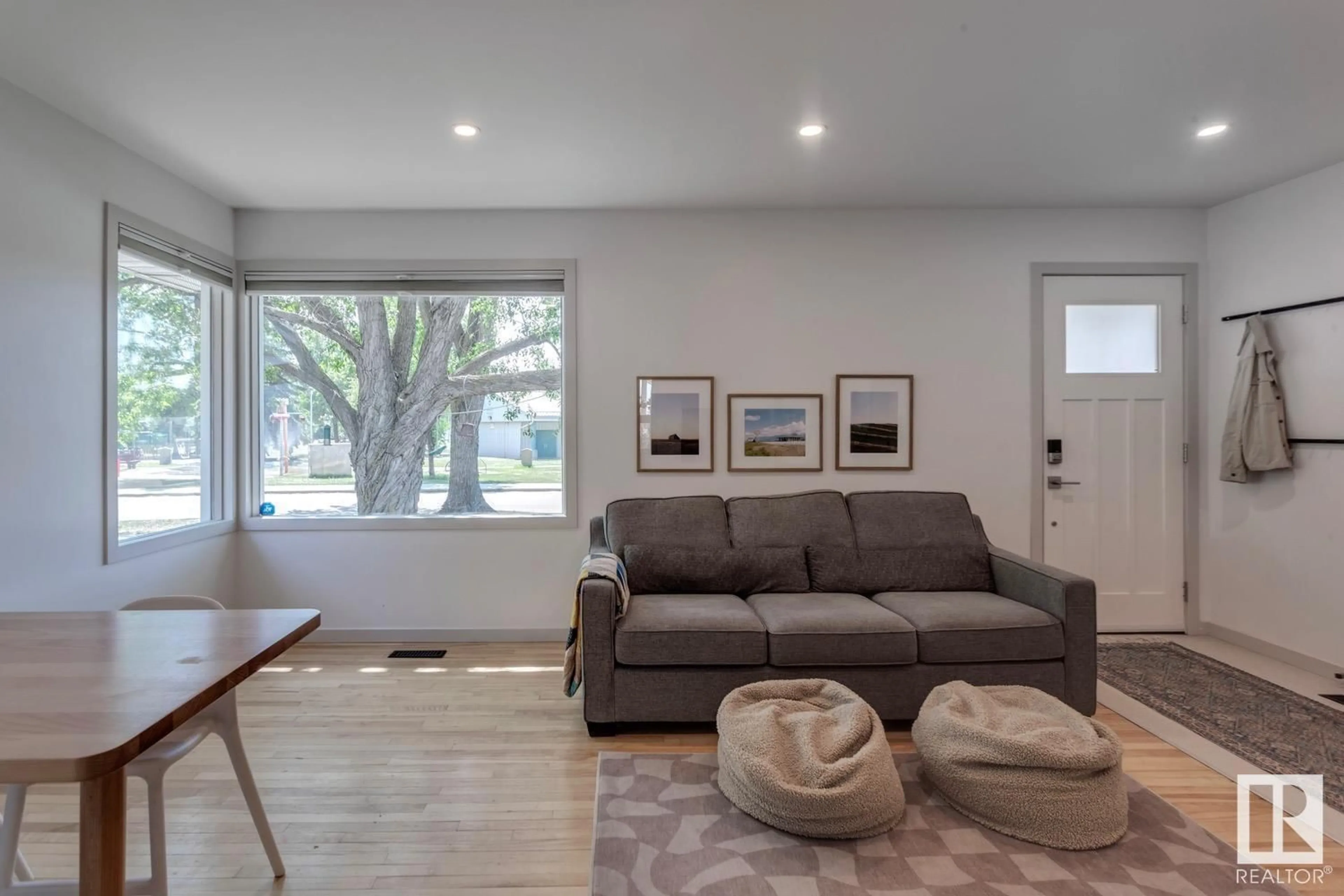 Living room with furniture, wood/laminate floor for NW - 5910 120 AV, Edmonton Alberta T5W1L6