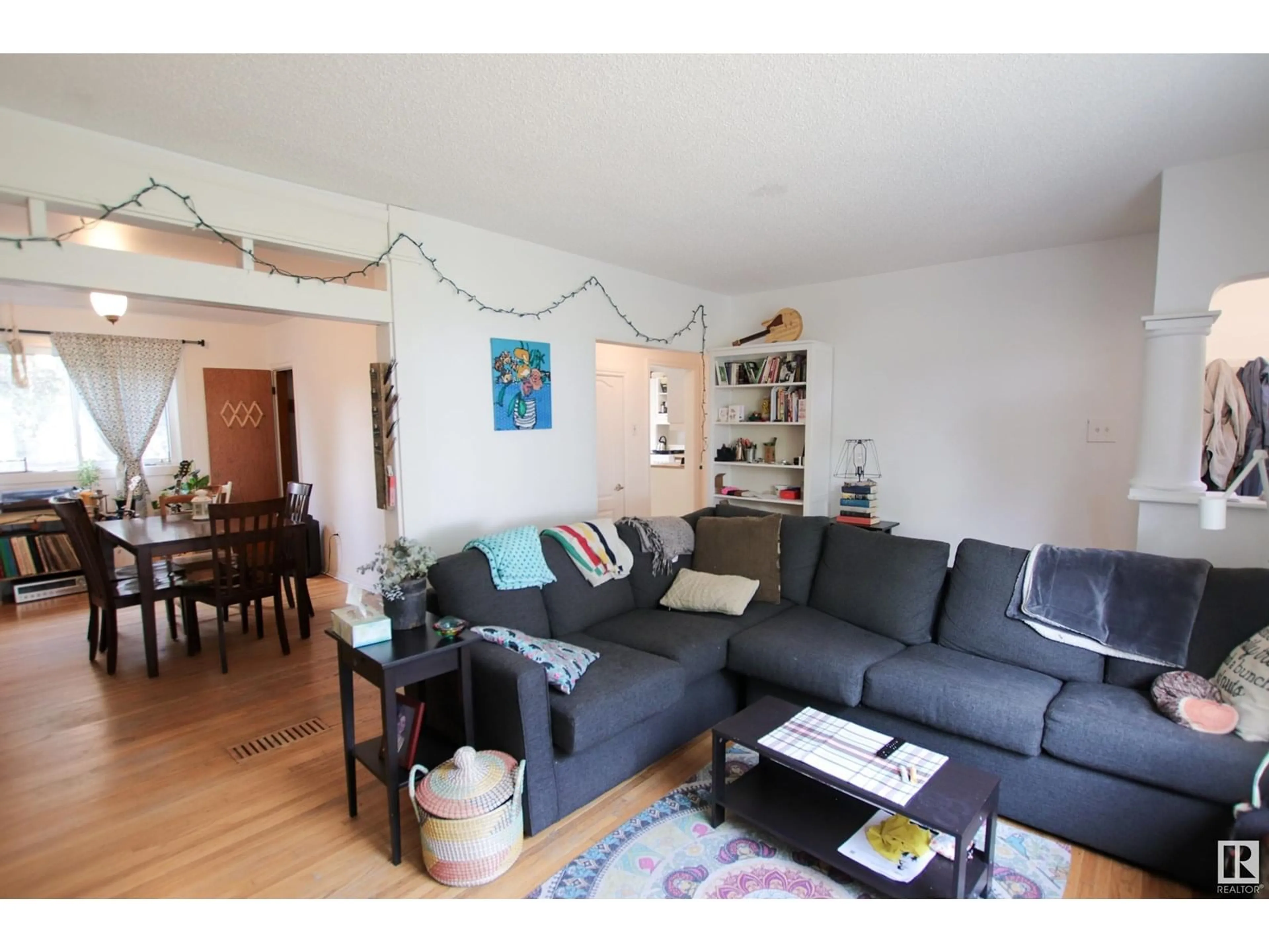 Living room with furniture, wood/laminate floor for 10544 66 AV, Edmonton Alberta T6H1X4