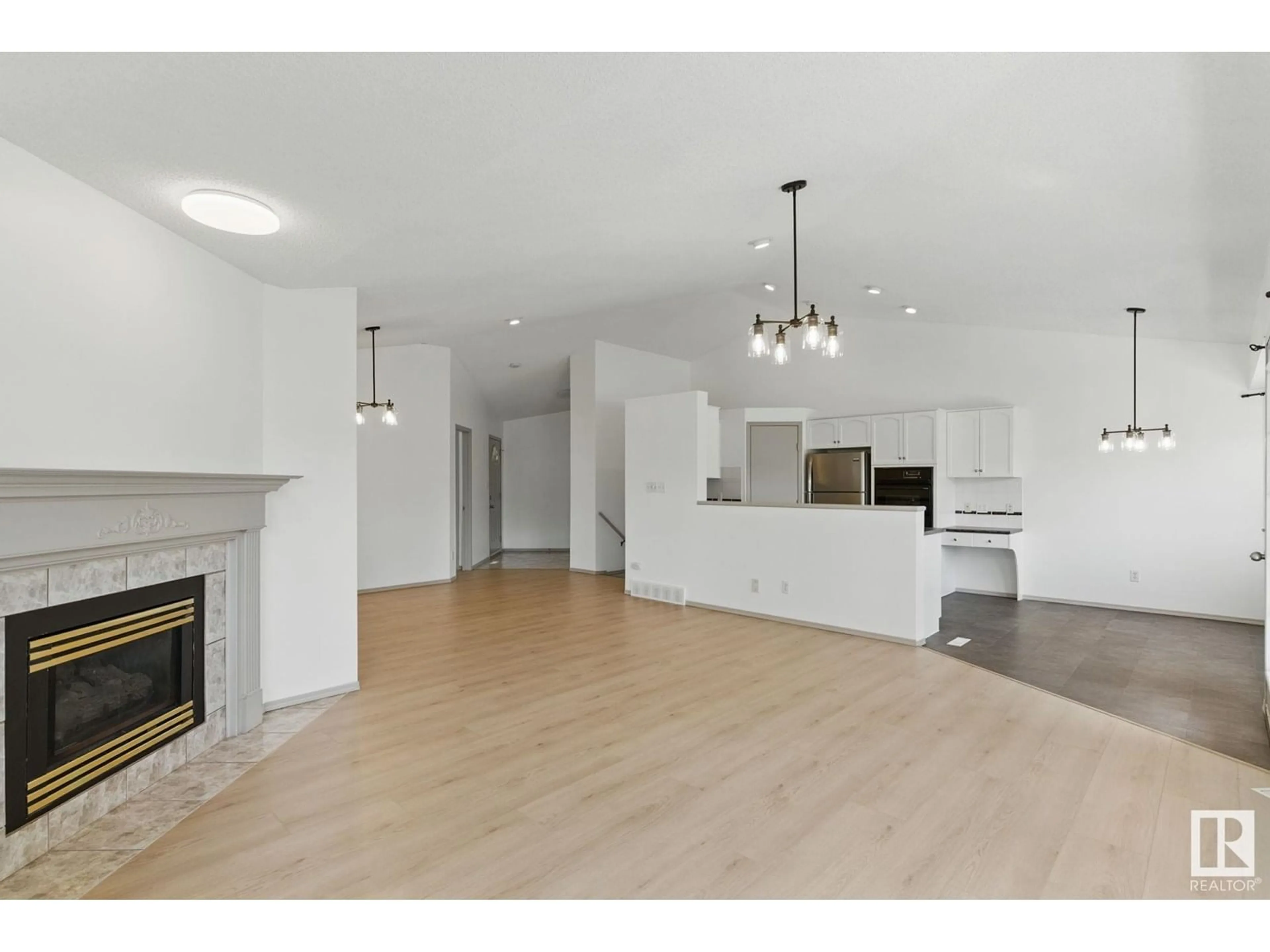 Open concept kitchen, wood/laminate floor for 9971 178 AV, Edmonton Alberta T5X5X2