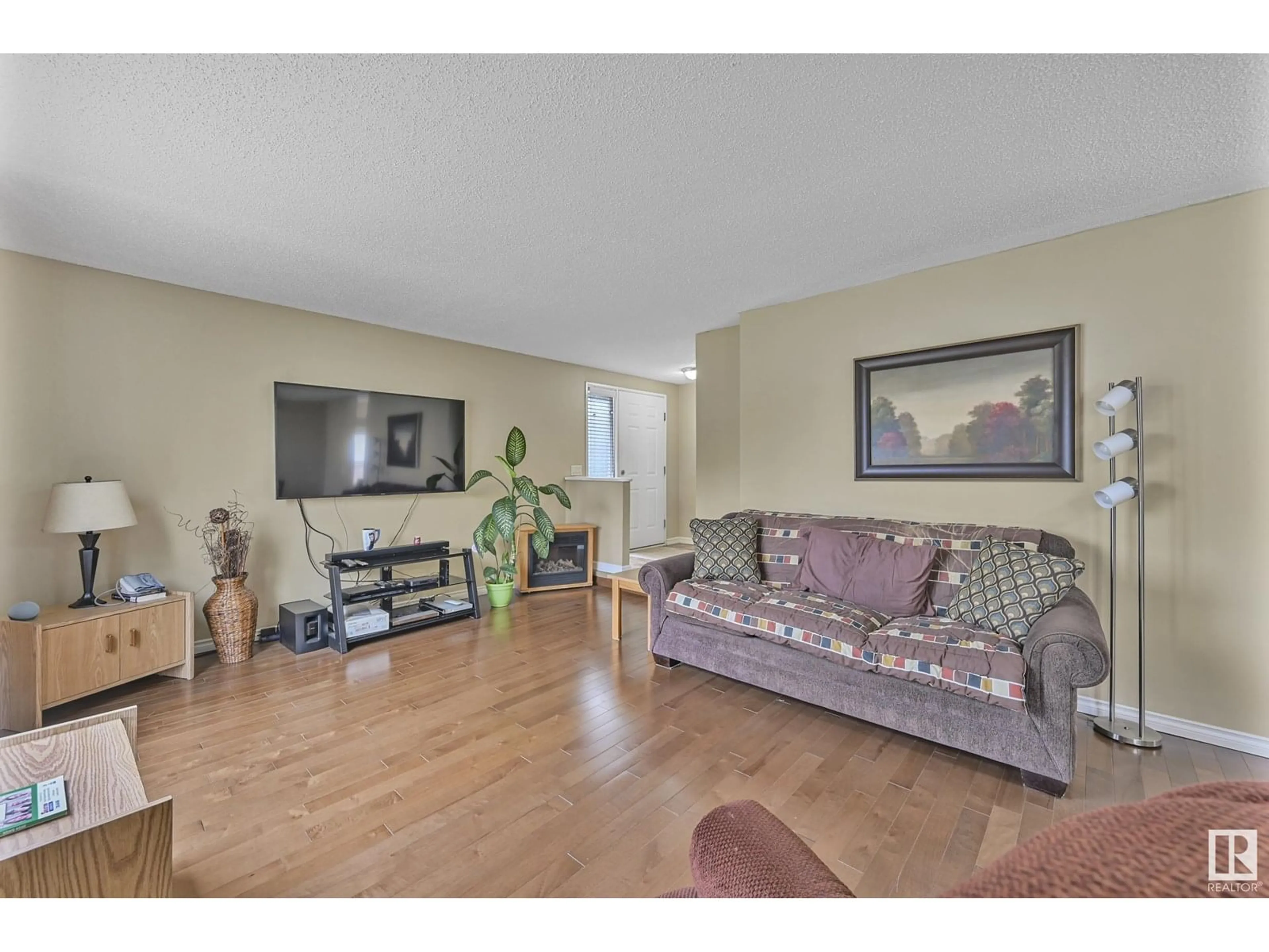Living room with furniture, wood/laminate floor for 1550 LAKEWOOD RD, Edmonton Alberta T6K2V9