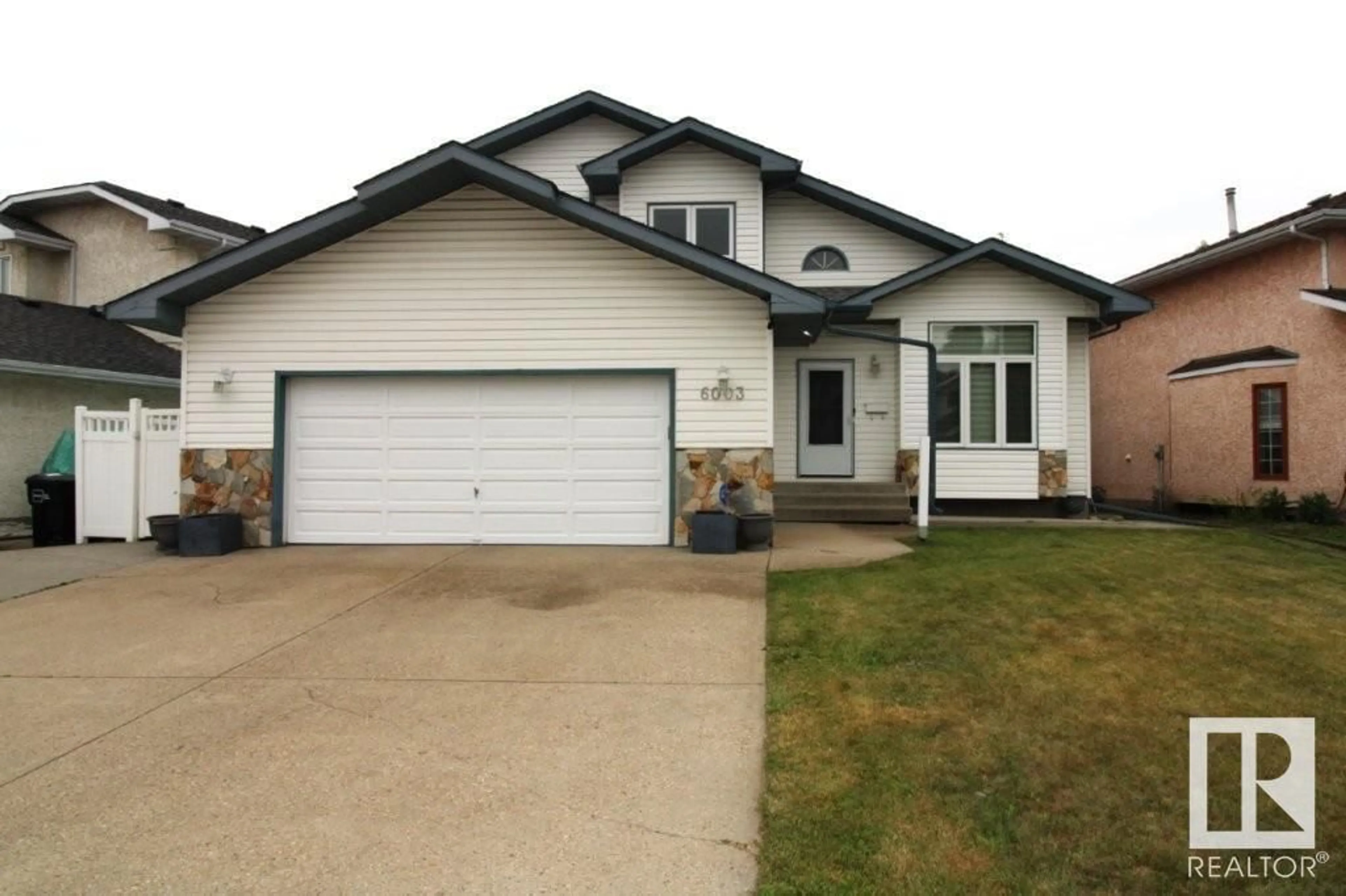 Home with vinyl exterior material, street for NW - 6003 156 AV, Edmonton Alberta T5Y2M8