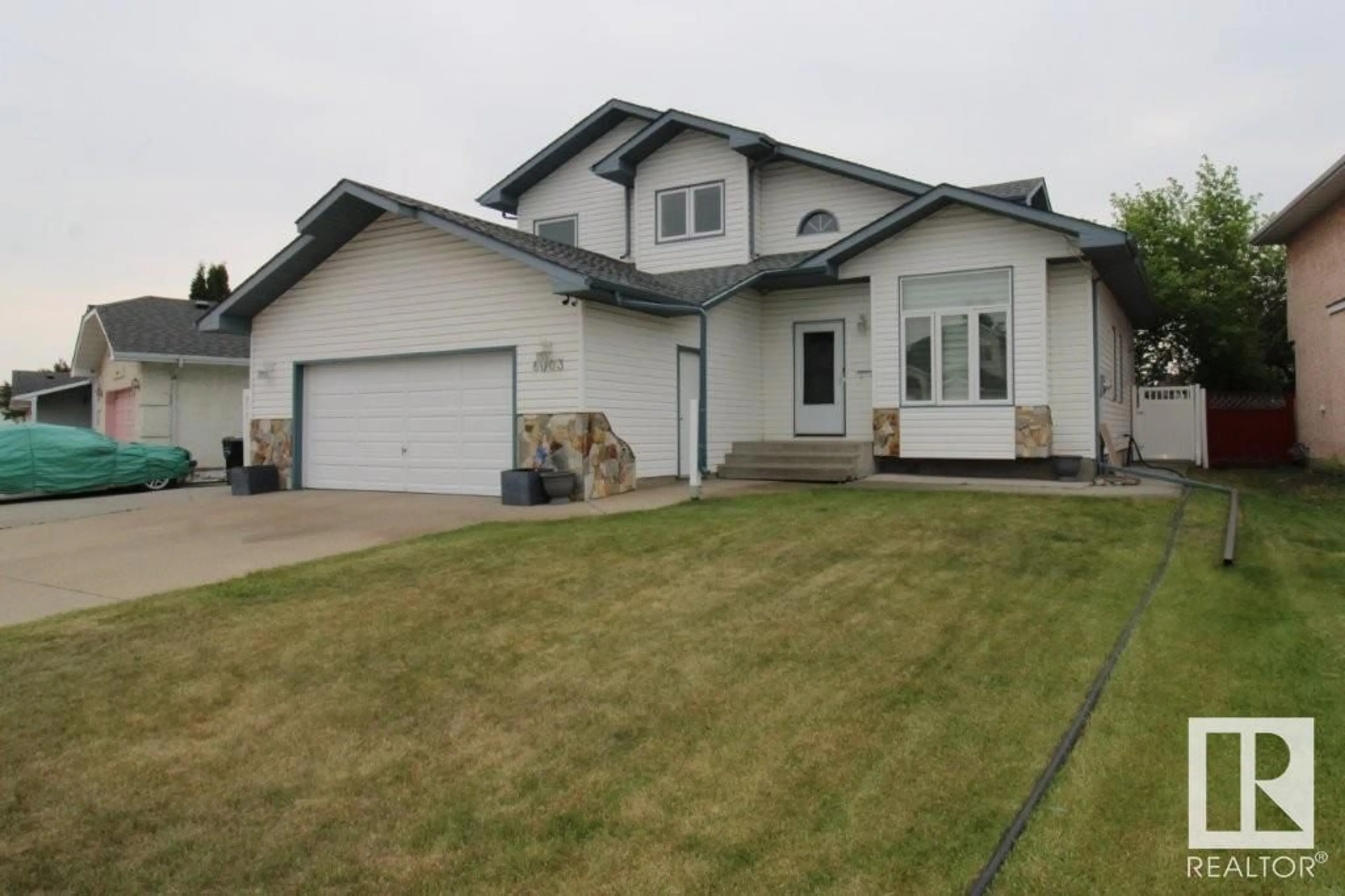 Home with vinyl exterior material, street for NW - 6003 156 AV, Edmonton Alberta T5Y2M8