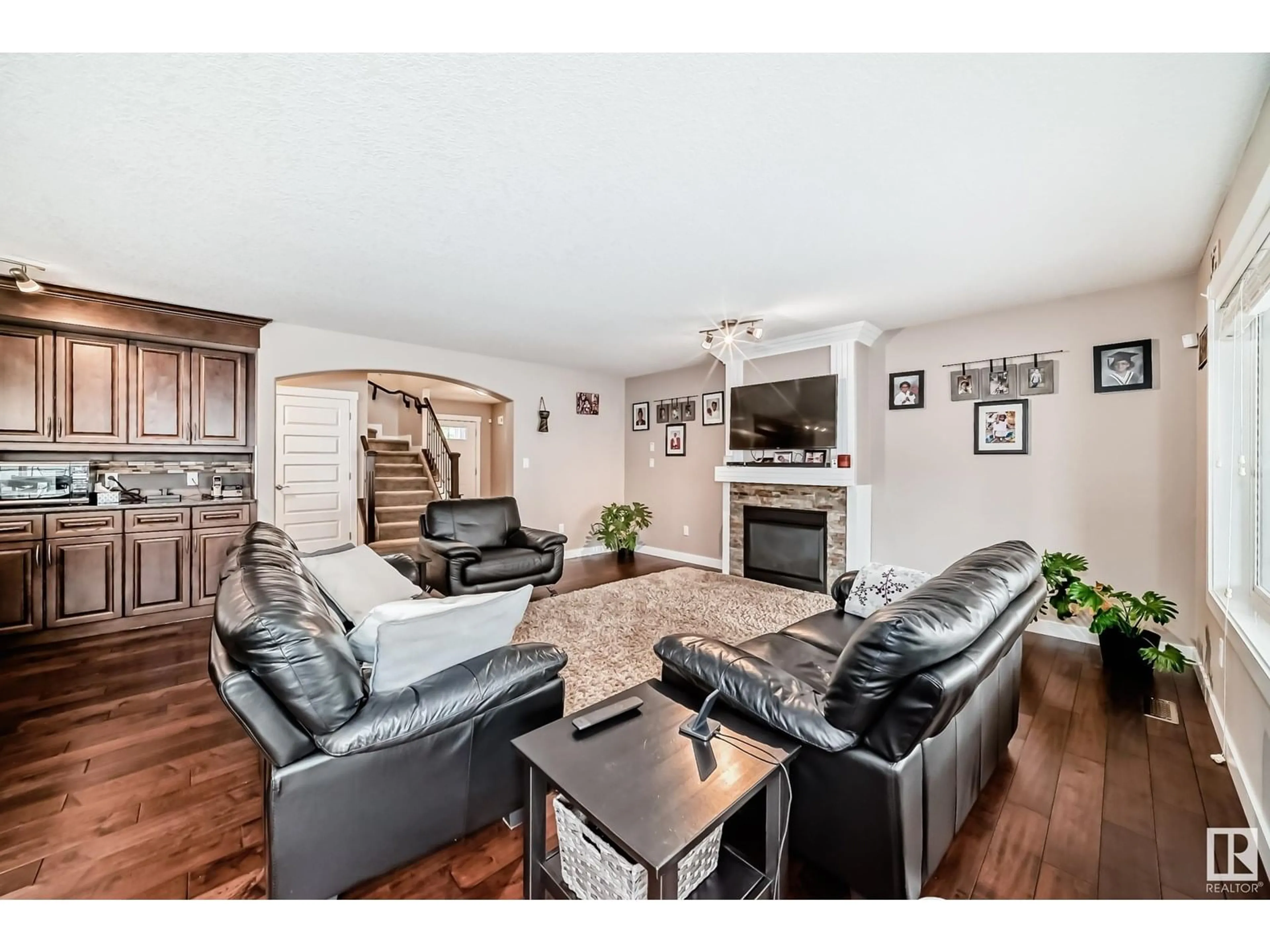 Living room with furniture, wood/laminate floor for 8710 180A AV, Edmonton Alberta T5Z0G6