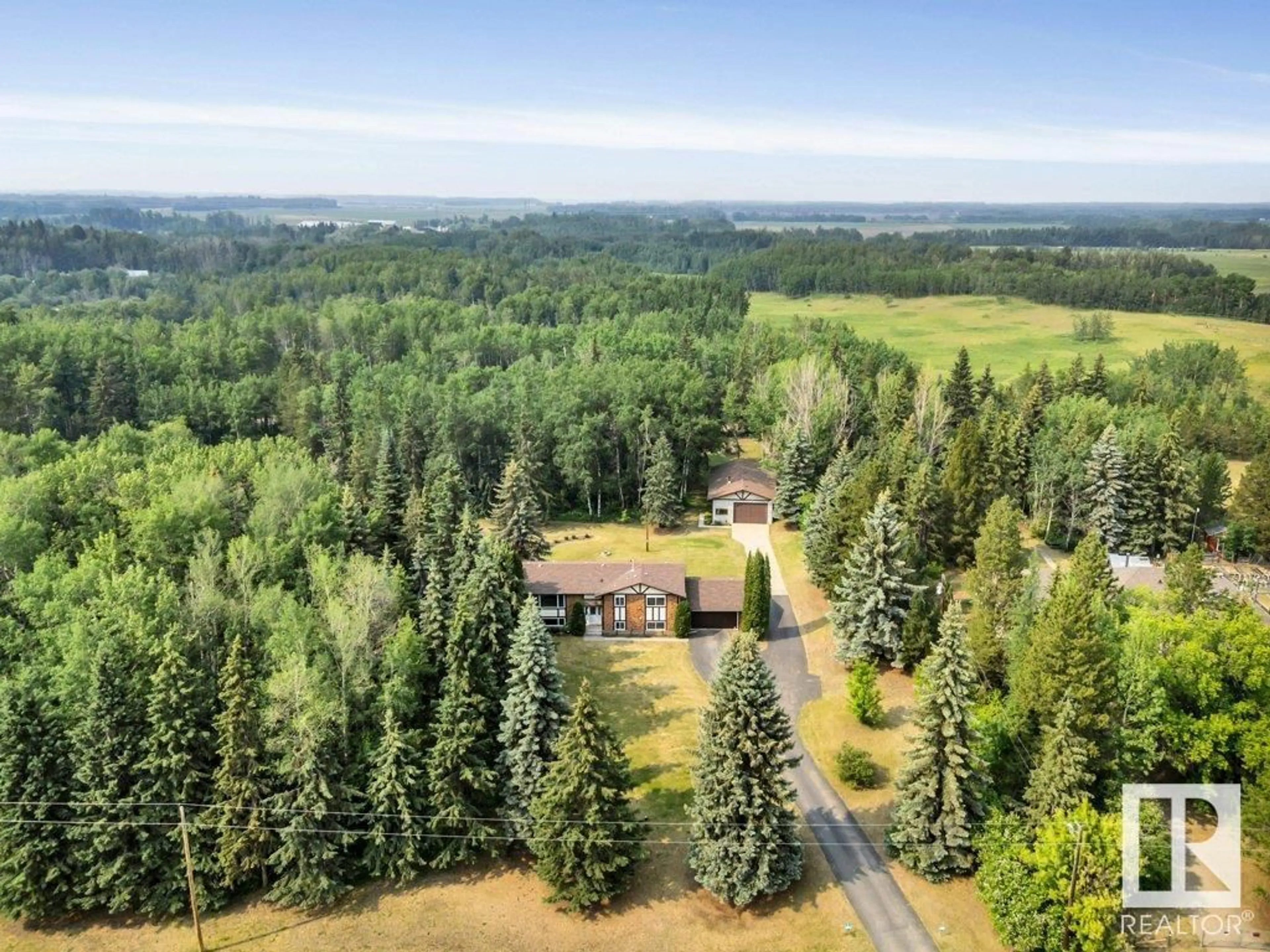 A pic from outside/outdoor area/front of a property/back of a property/a pic from drone, forest/trees view for 51513 - 6 RGE RD 265, Rural Parkland County Alberta T7Y1E3